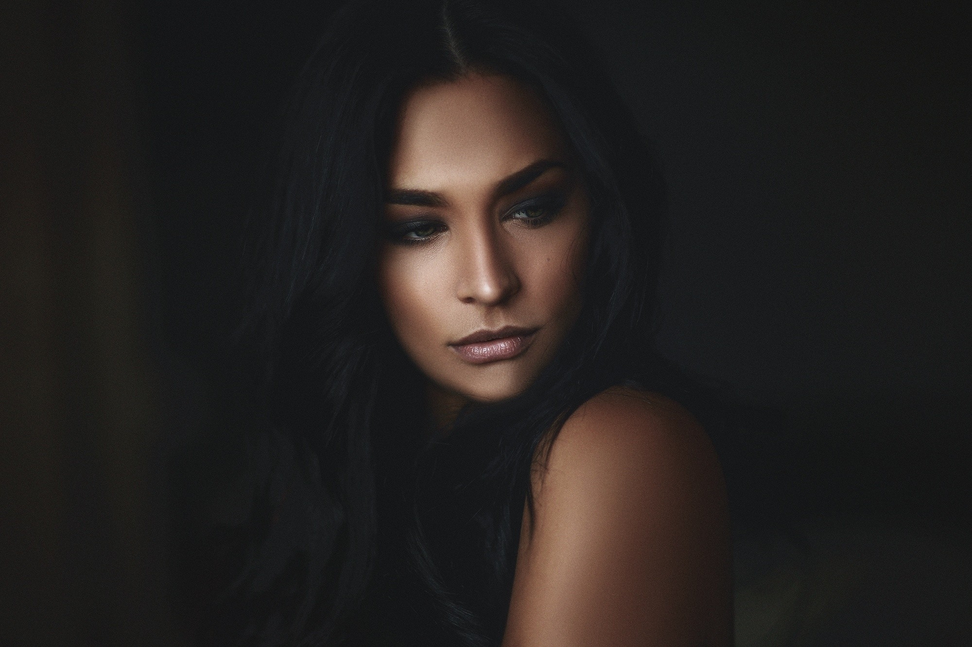 Portrait of a brunette on a black background
