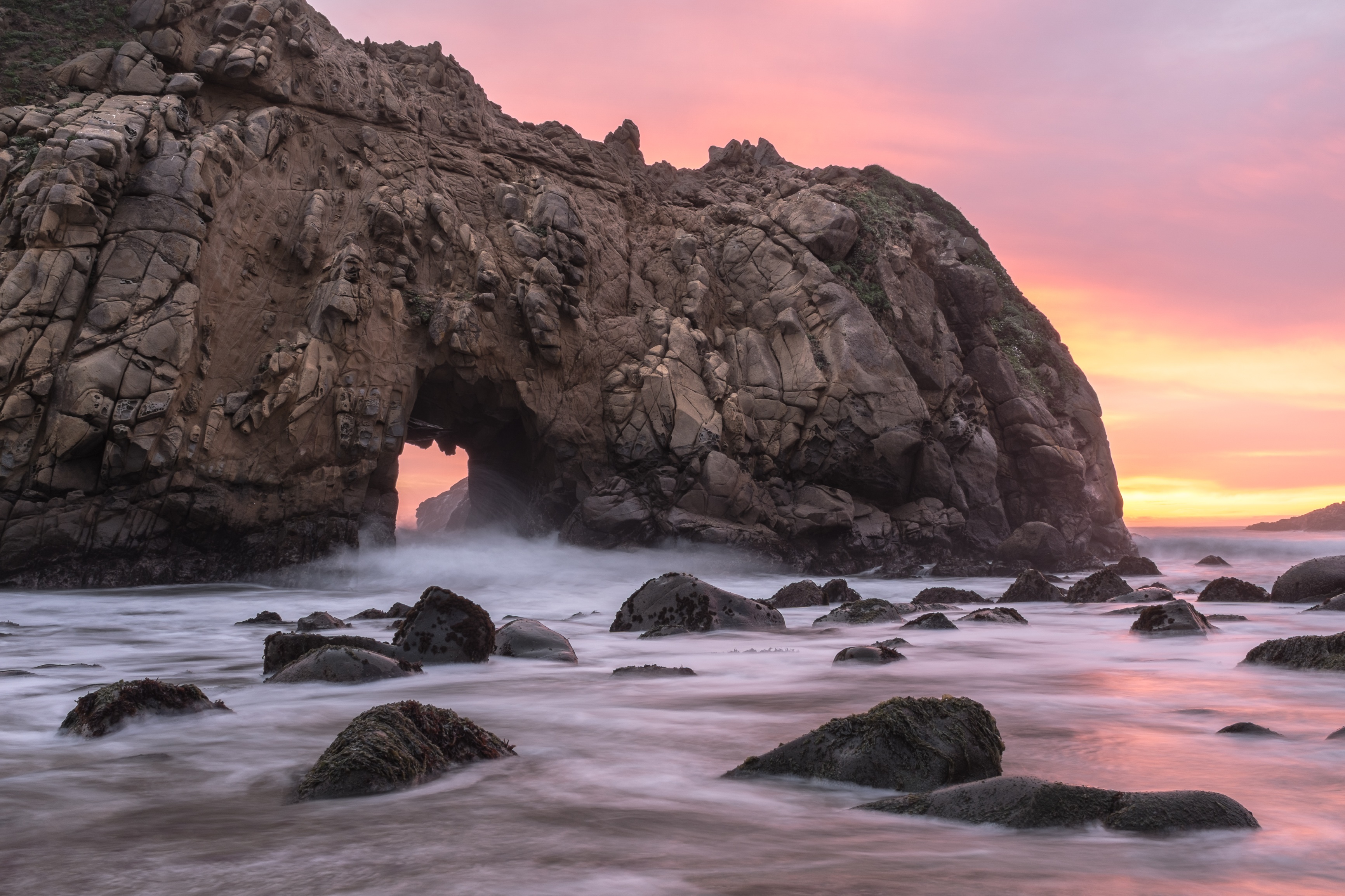 Free photo A large rock on the seashore at sunset