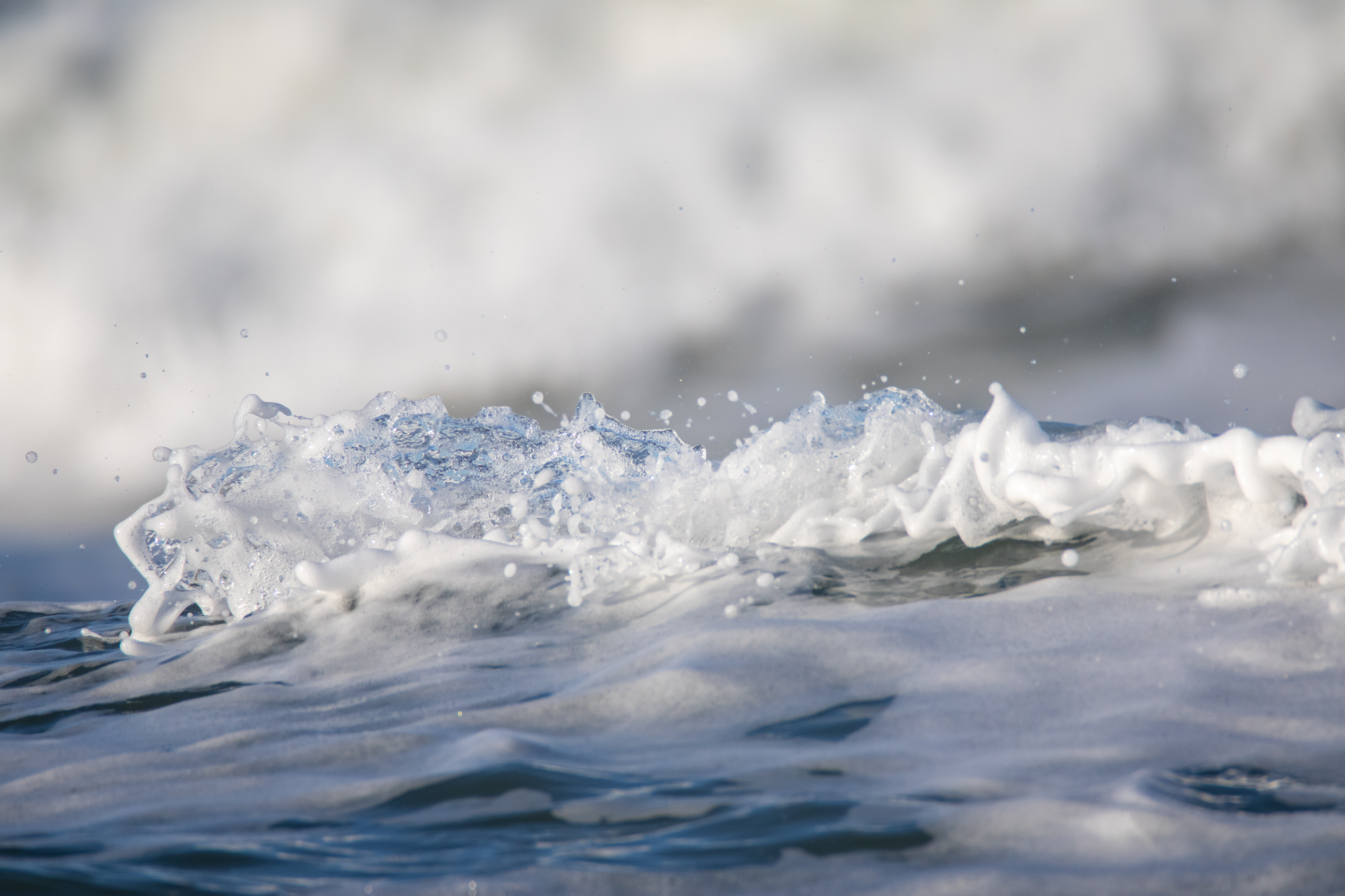 Splashing water with foam at the riverbank