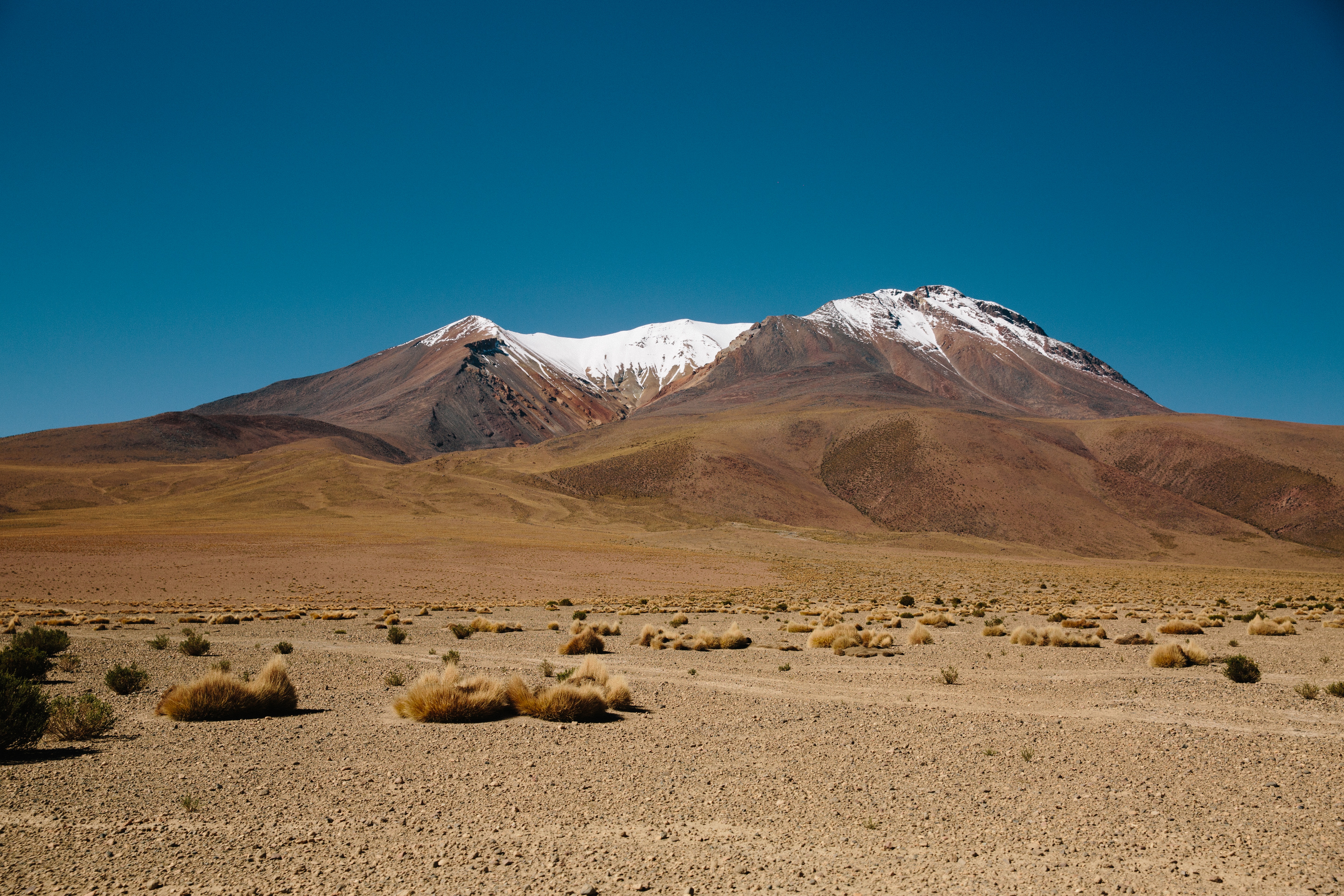 Free photo A mountain in the desert with snow on the hill