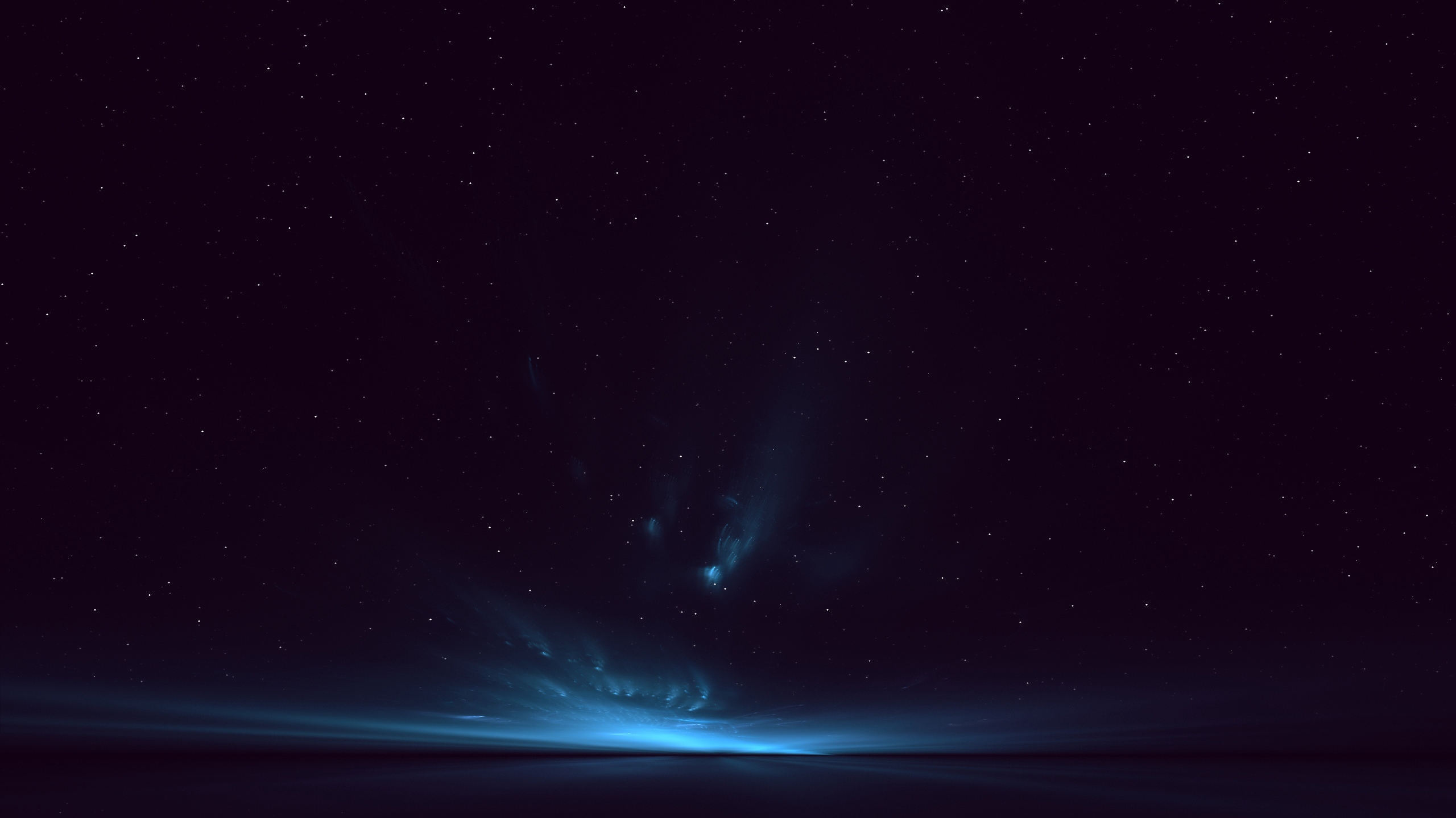 Blue light in the night sky by the horizon of the sea