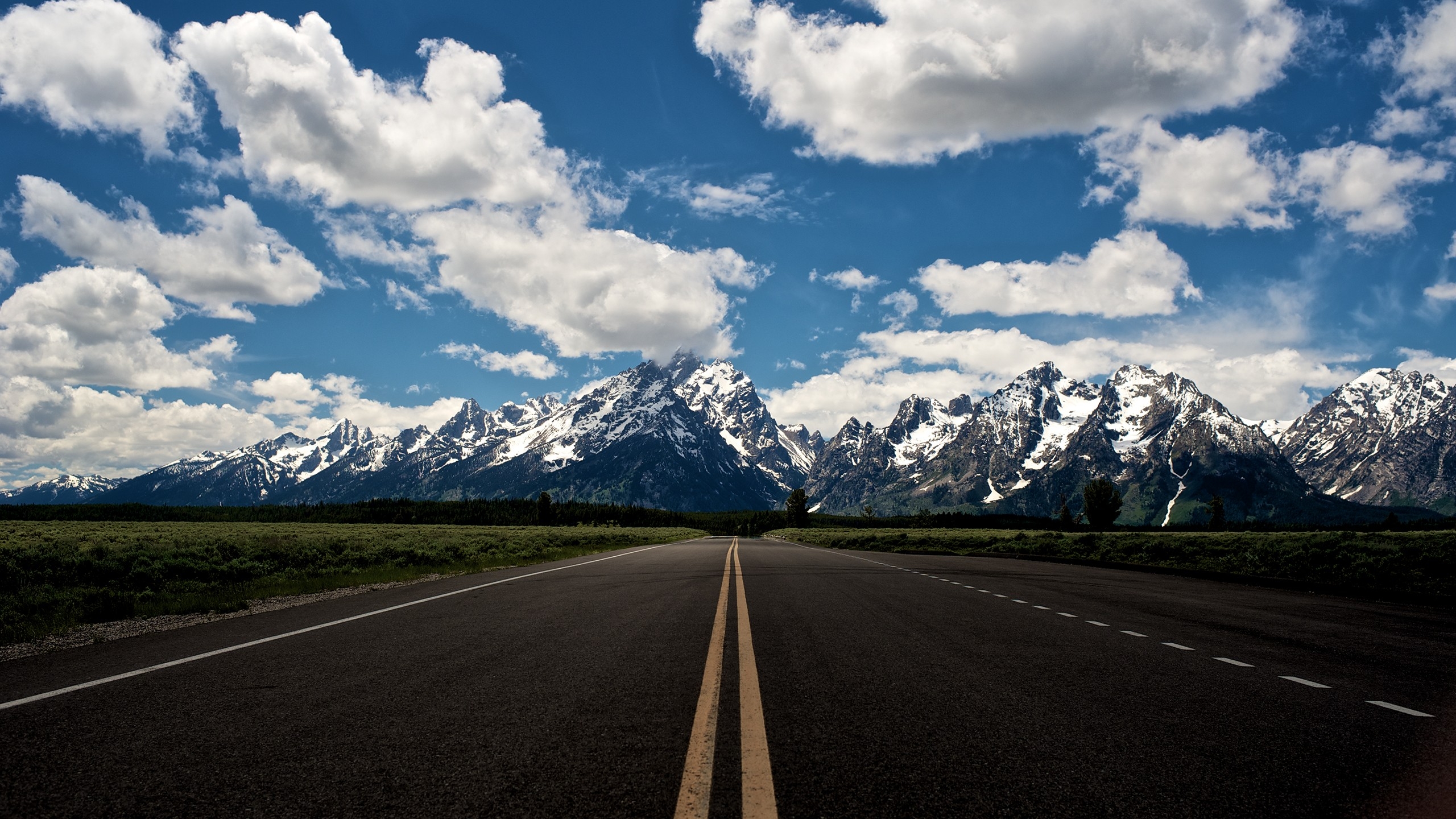 Wallpapers a long road fields mountains on the desktop