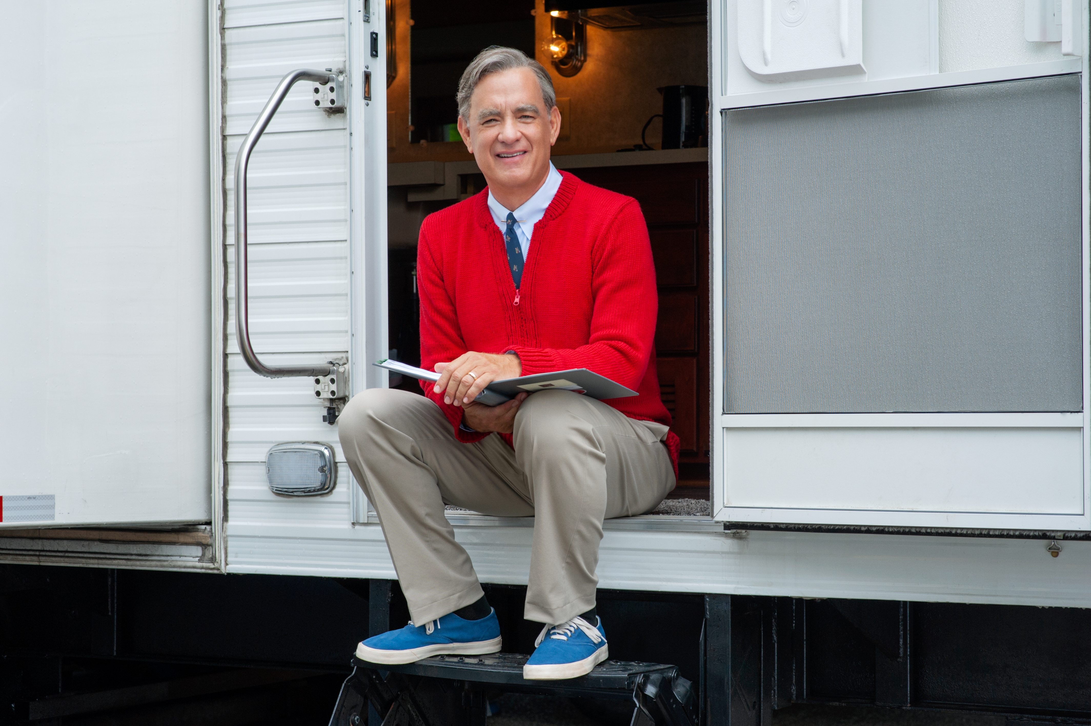 Free photo Tom Hanks sits on the doorstep with a book in his hands