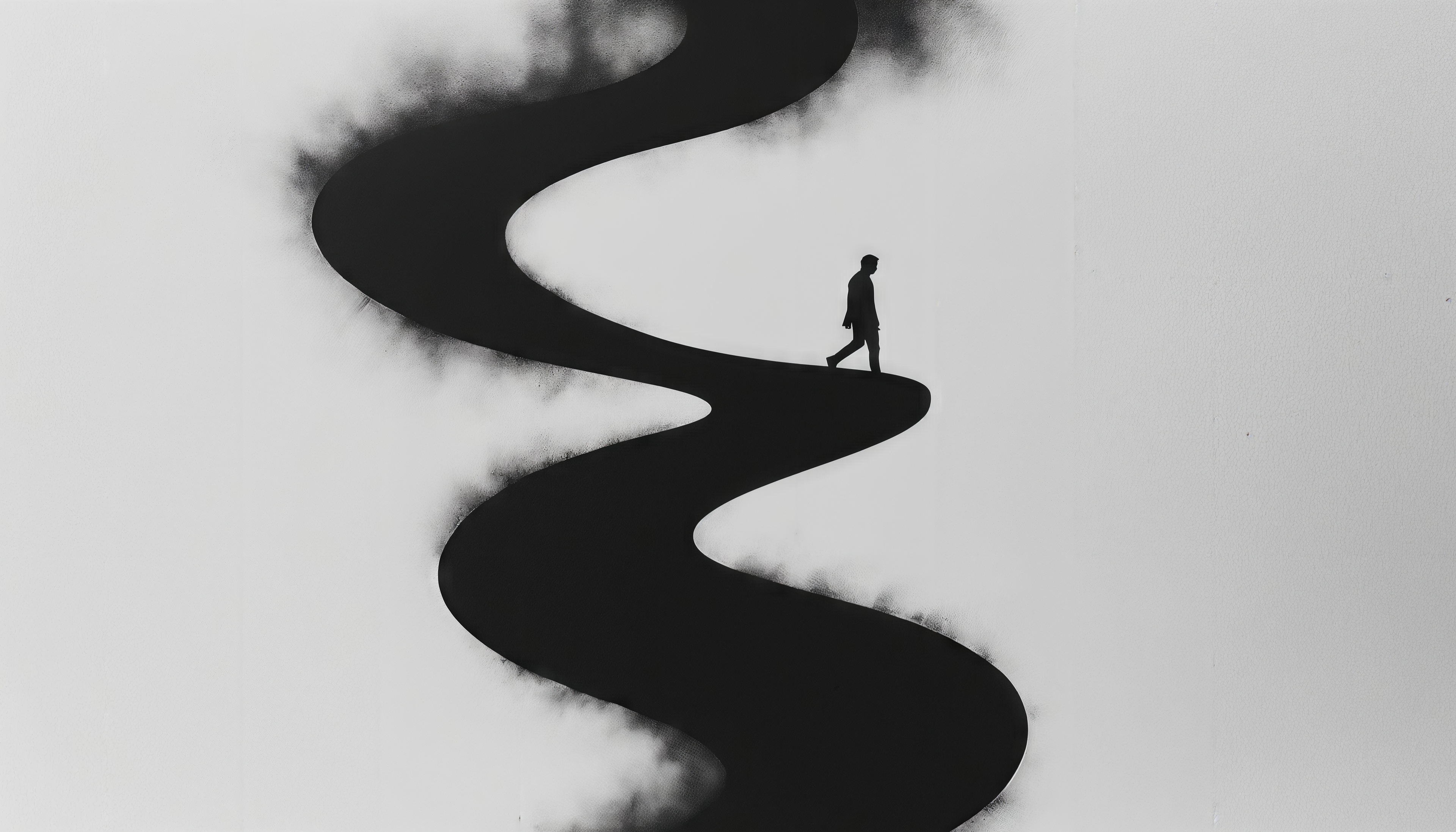 Бесплатное фото Чёрная извилистая тропа и одинокая фигура - метафора жизненного пути.