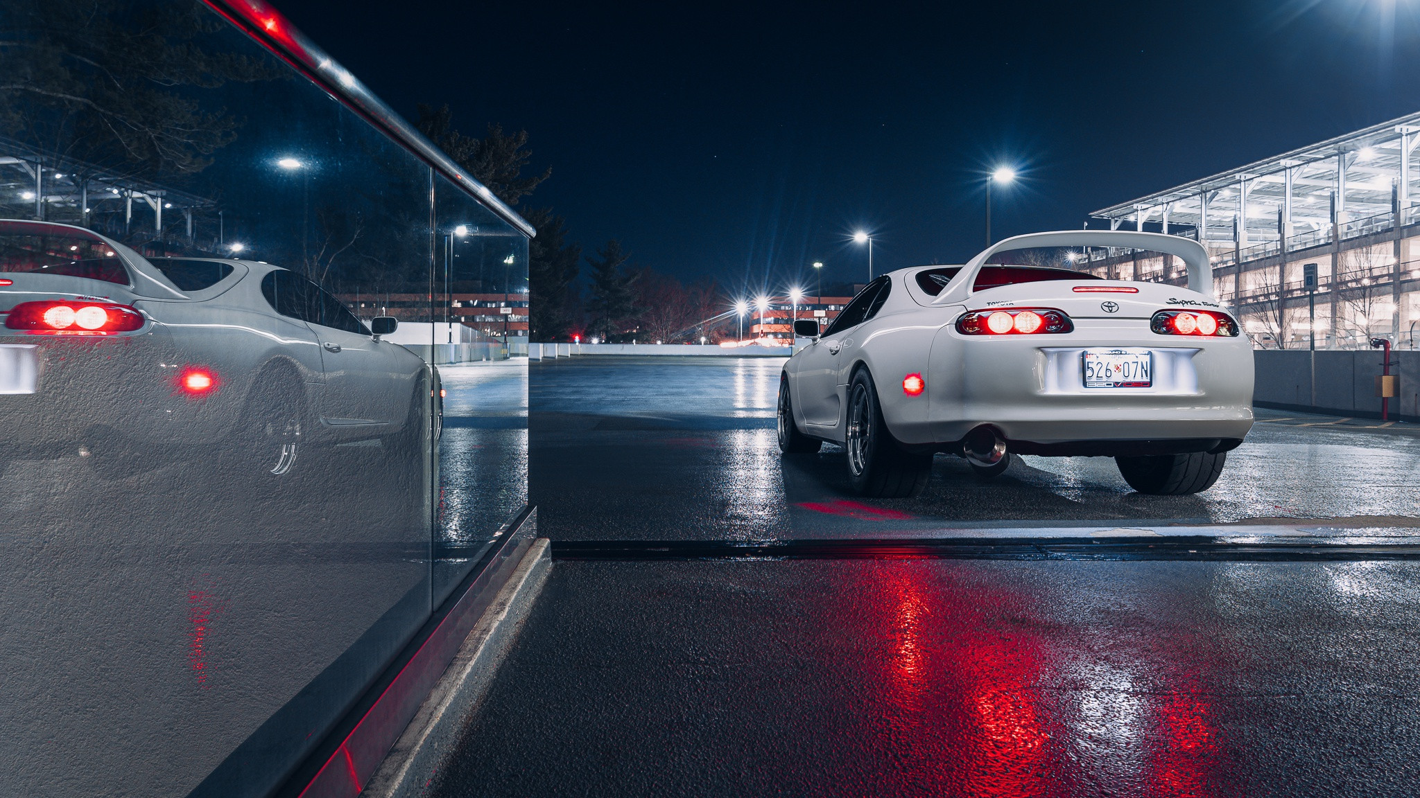 White Toyota Supra outside a mall at night