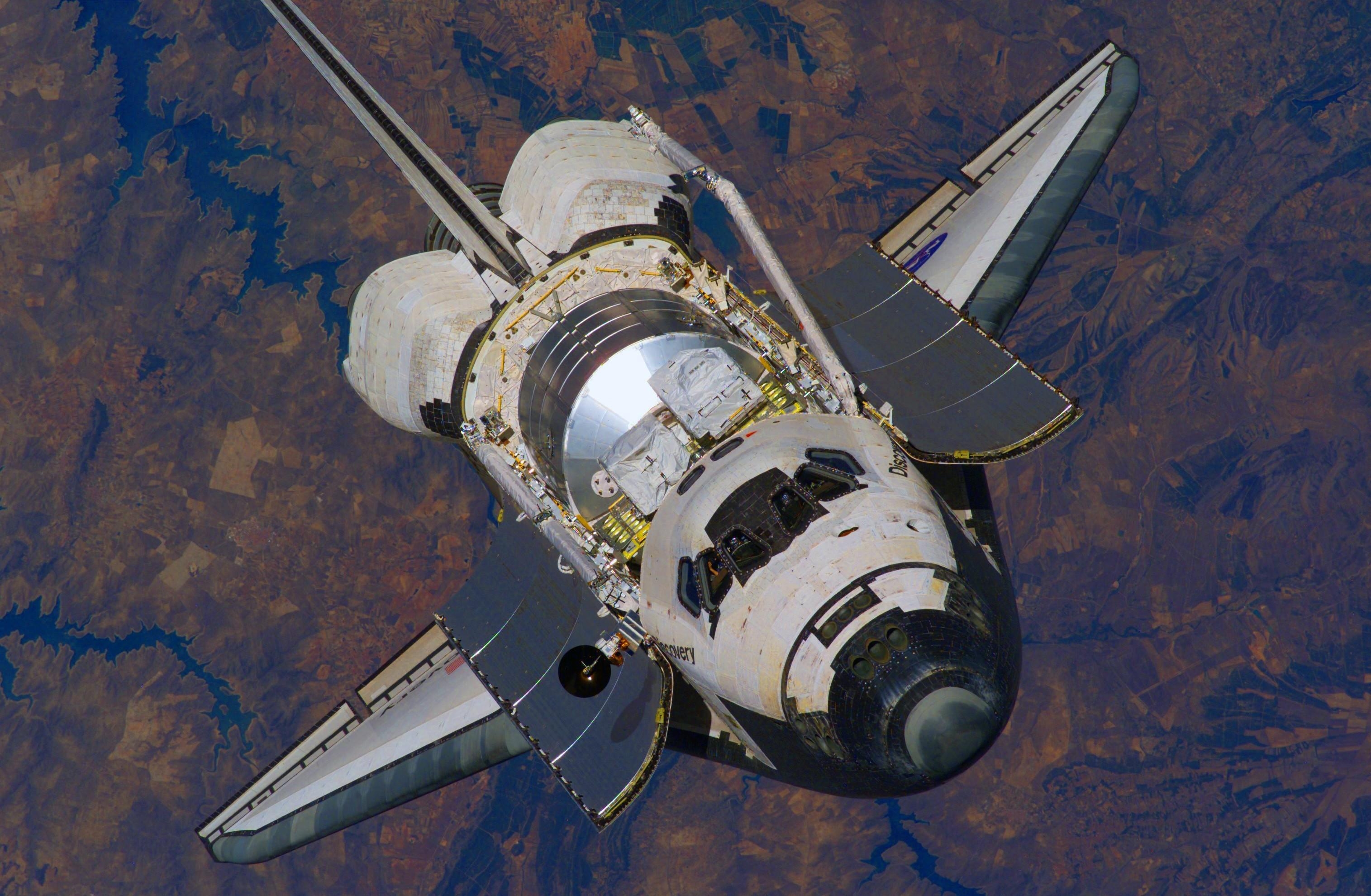 The silhouette of the shuttle Endeavour on the background of the colorful horizon of the Earth