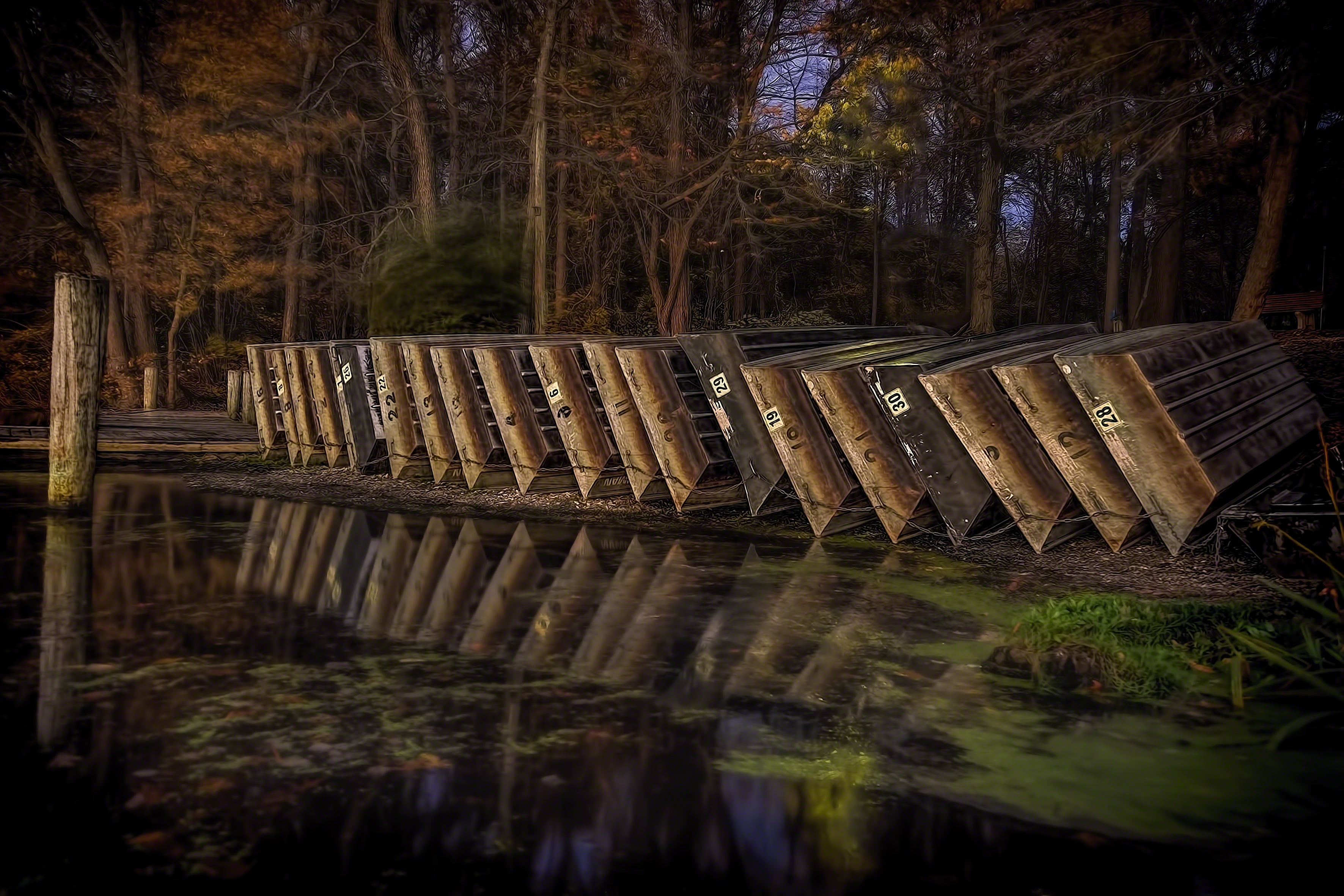 The boats are lined up and reflected in the water