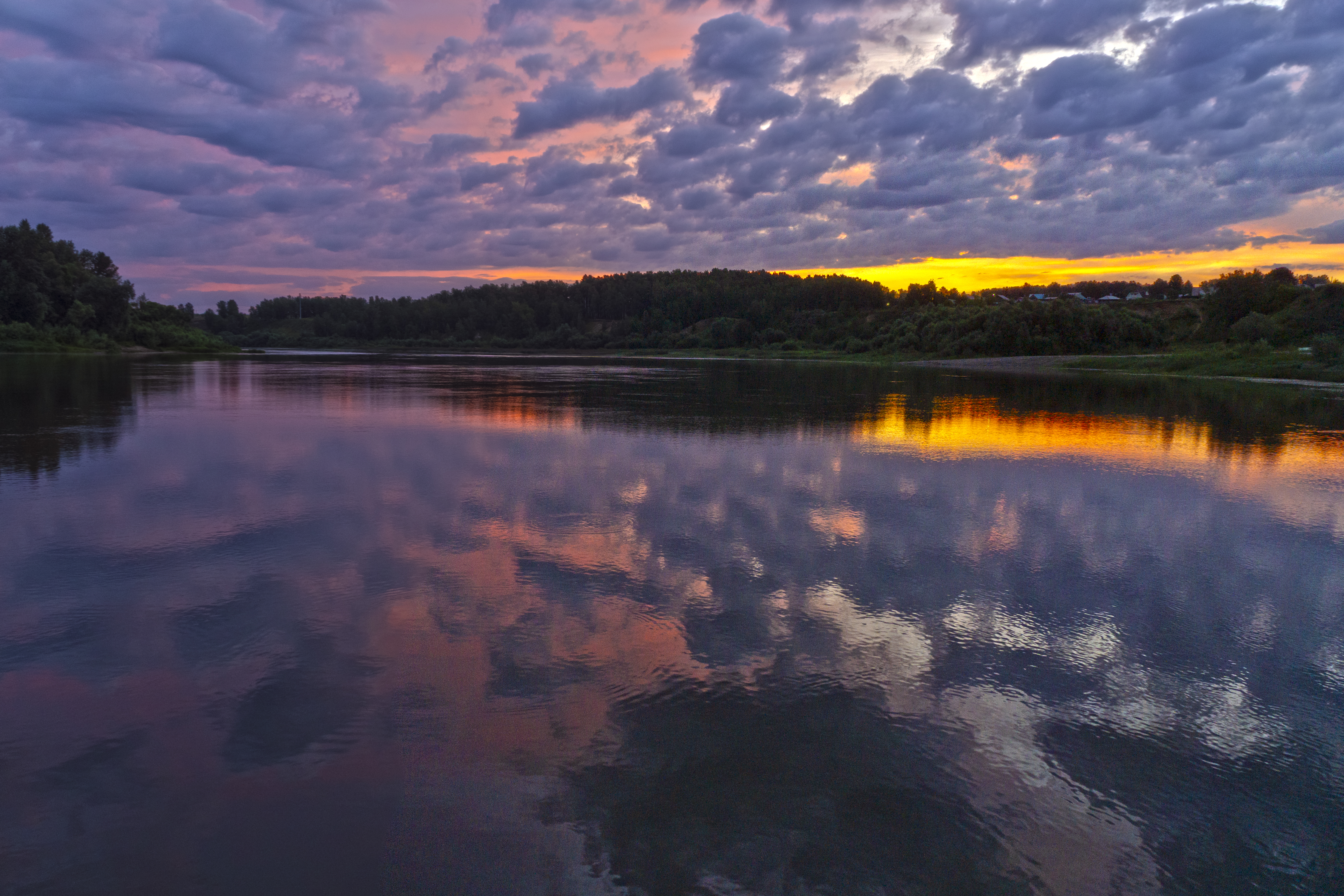 Fishing during dawn on a river in Siberia