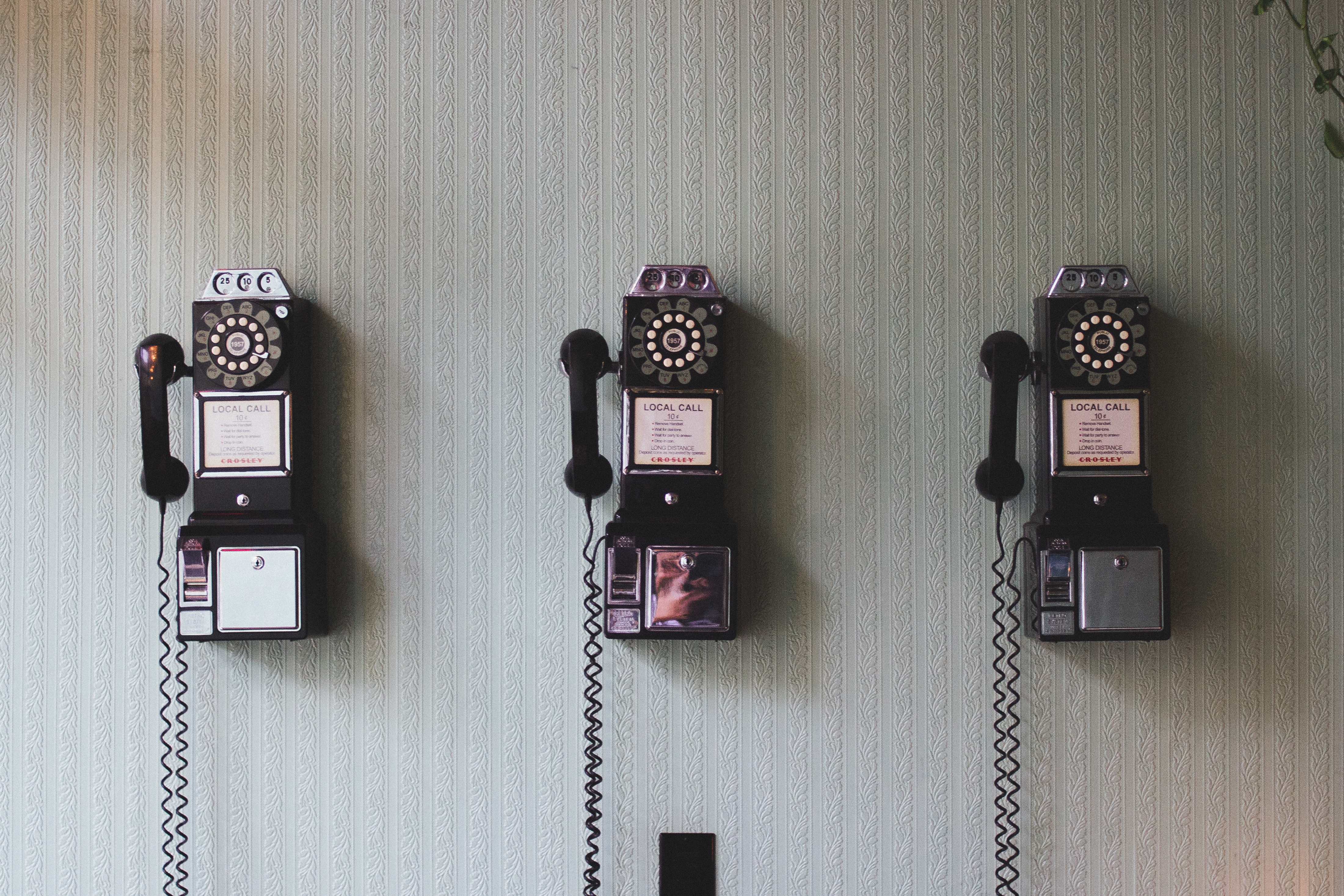 Free photo Three vintage vintage phones on the wall