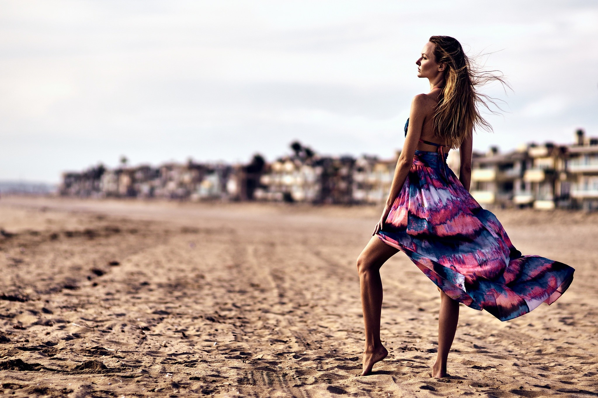 A girl posing on a windy shore