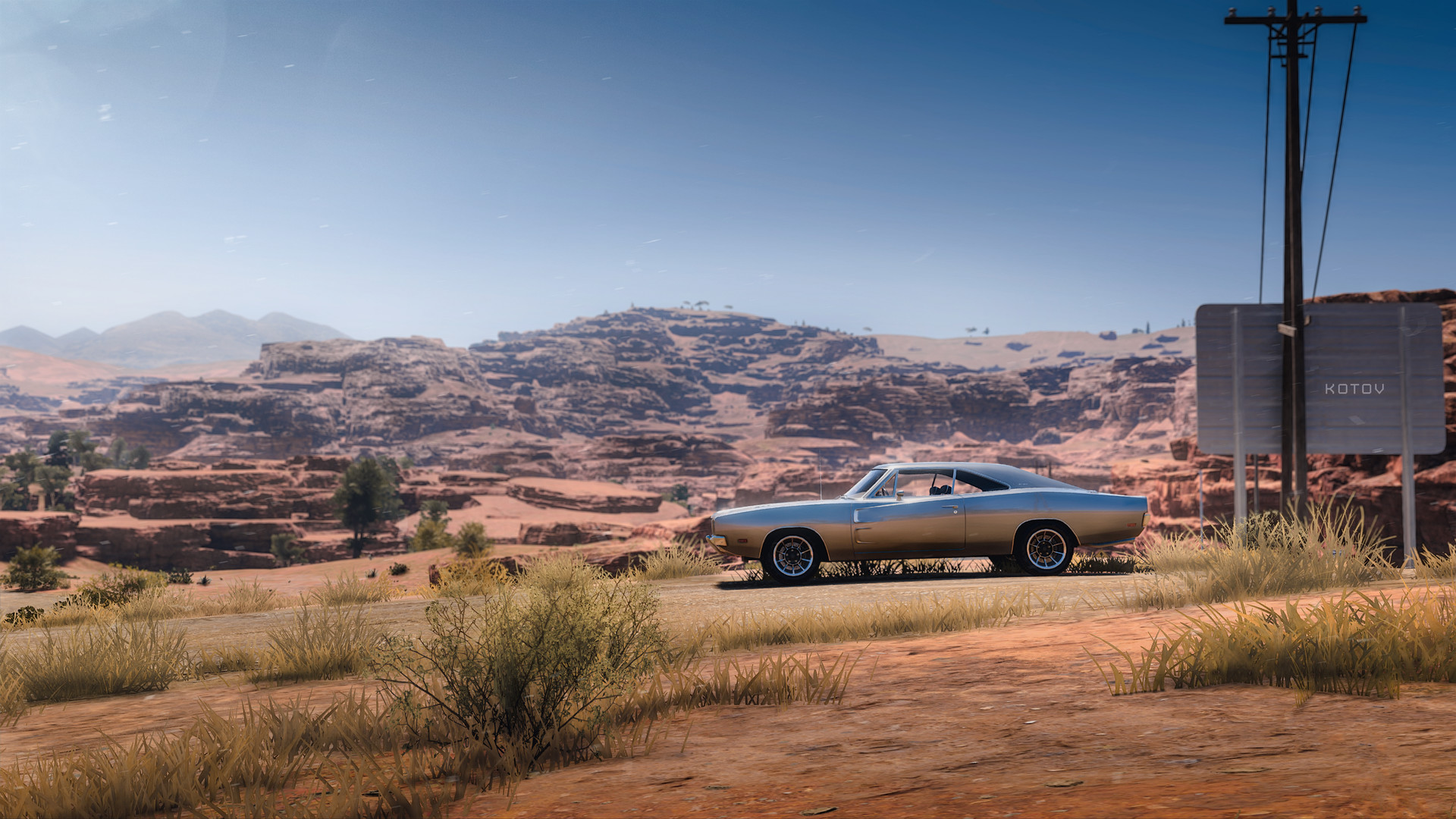 Free photo Dodge Charger against the backdrop of the roller coaster