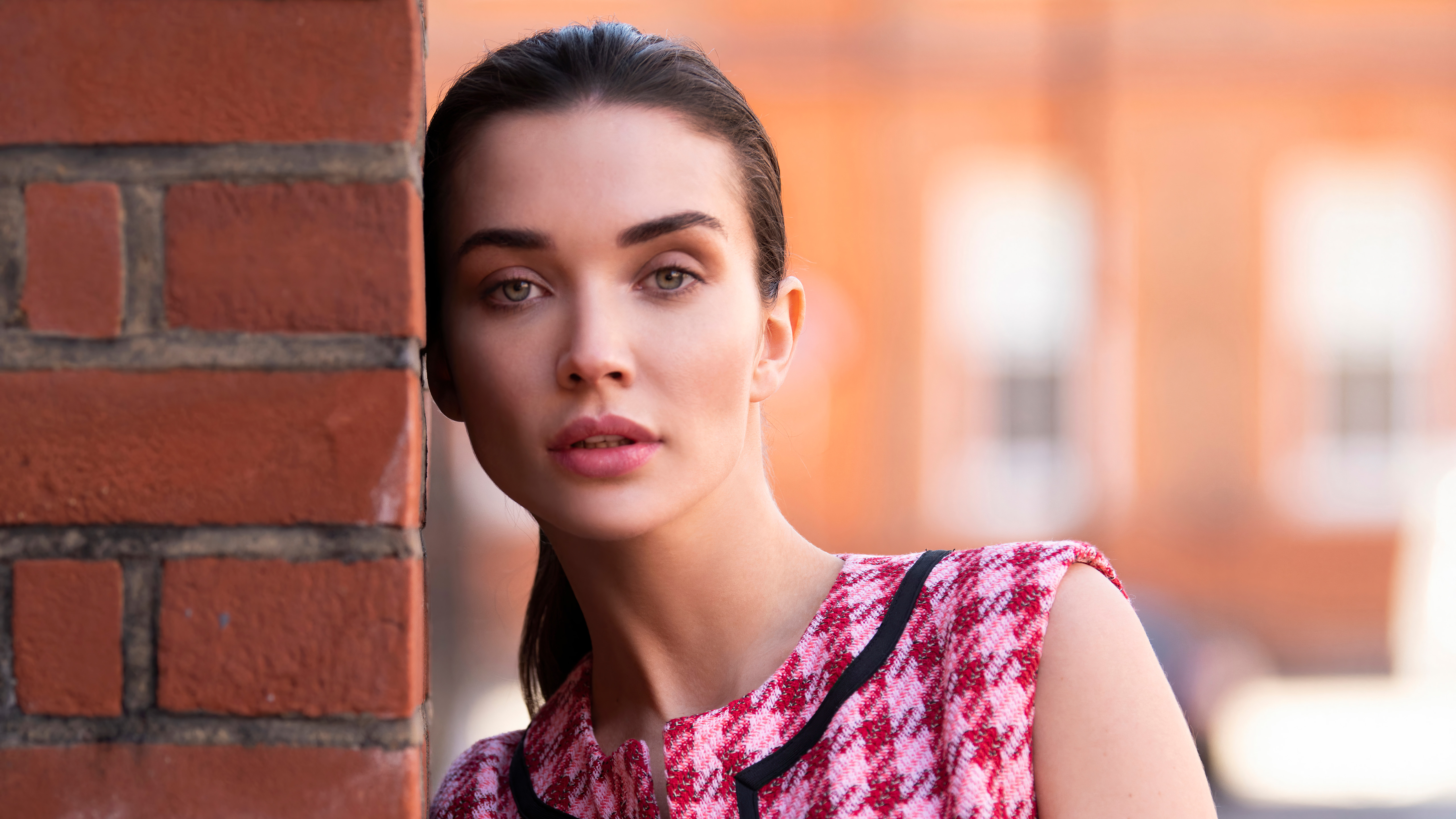 Free photo Amy Jackson is standing against a brick wall