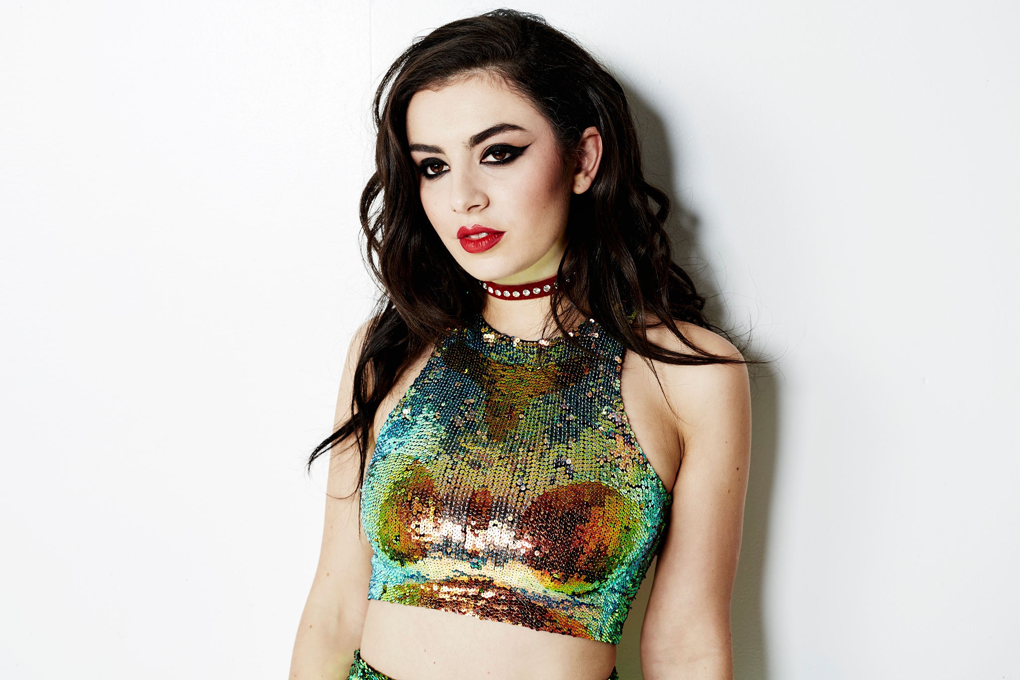 Black-haired Charli Xcx in a short sequined top