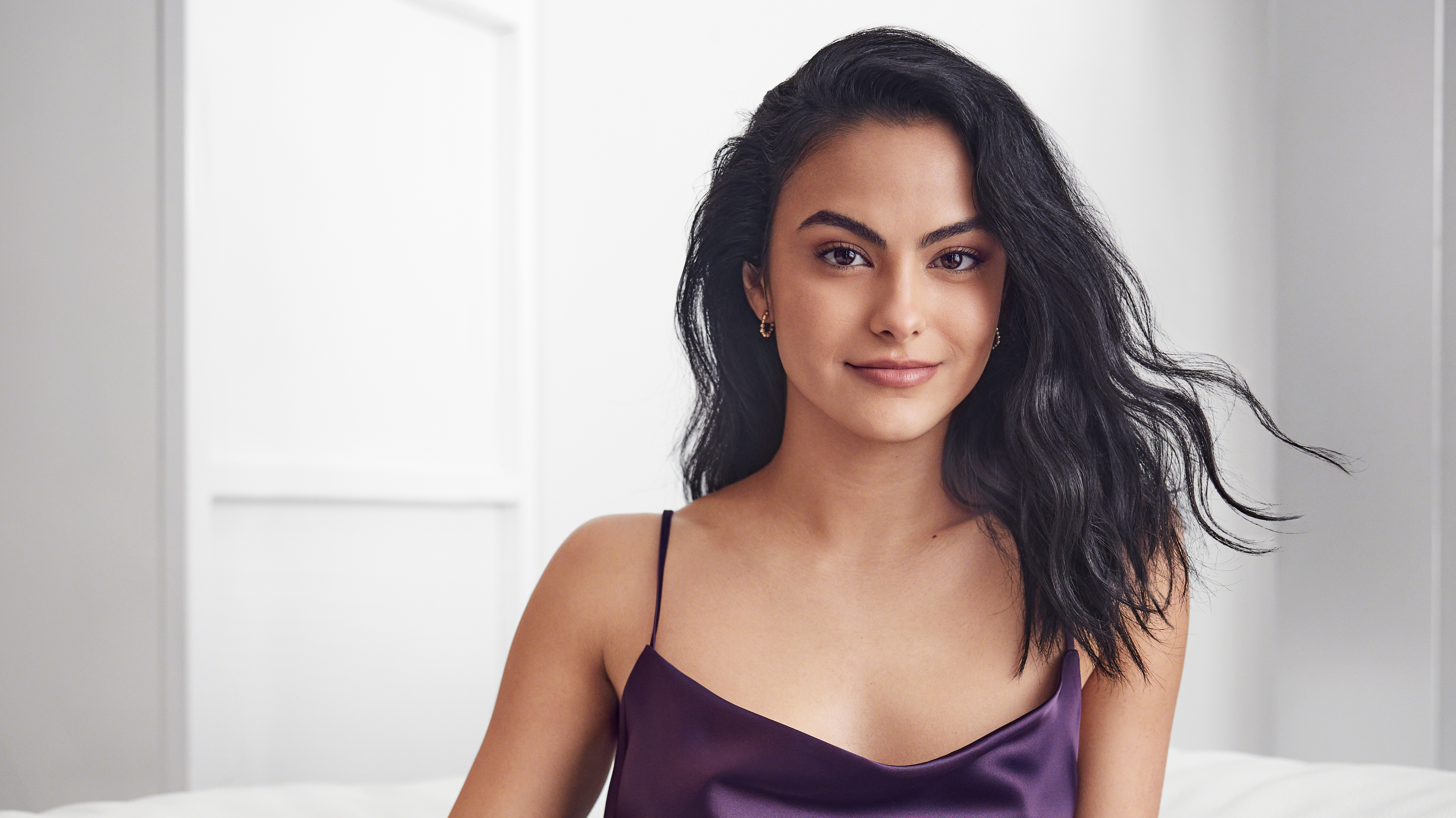 Brunette Camila Mendes in a tank top.