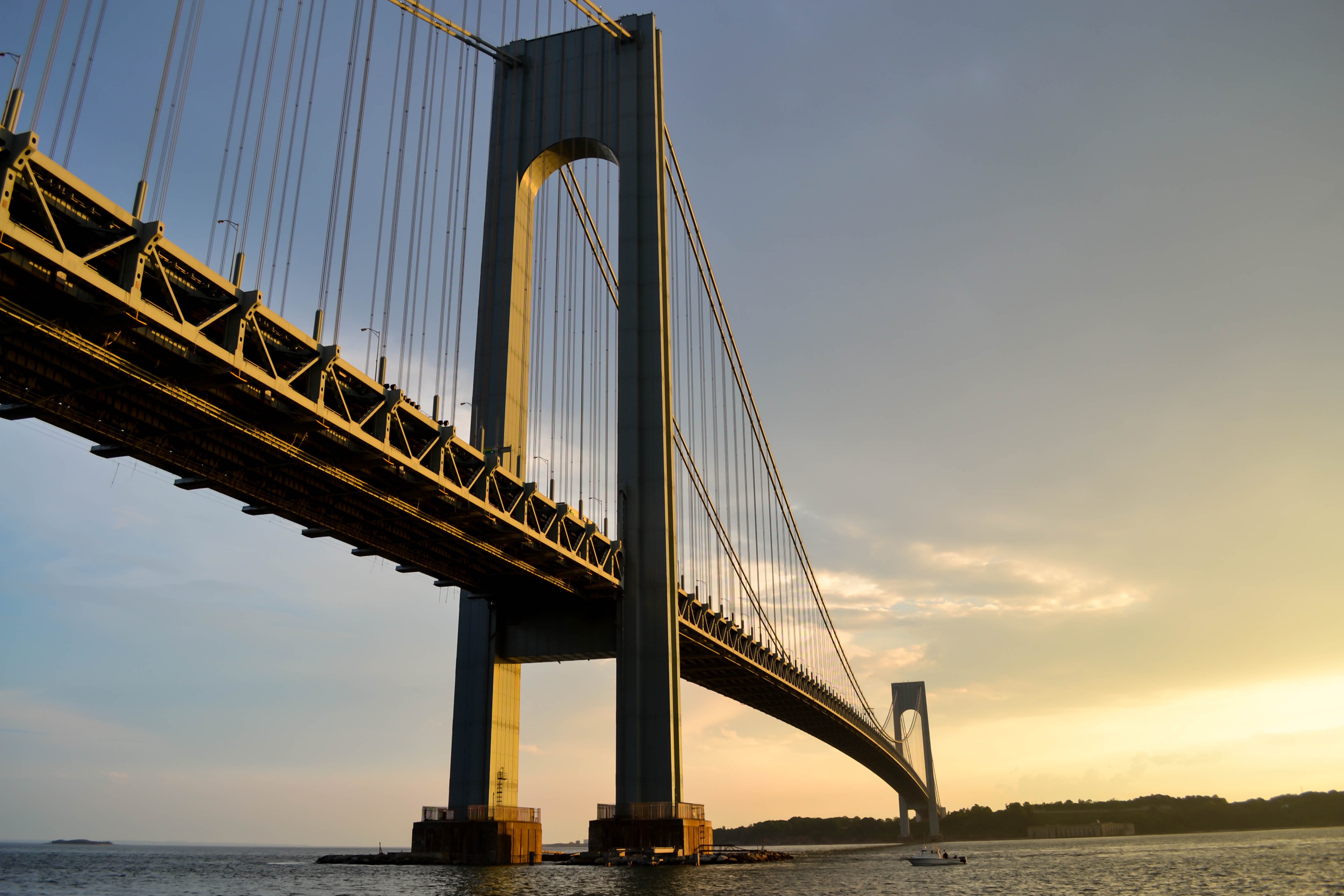 Free photo A large bridge over the river at sunset