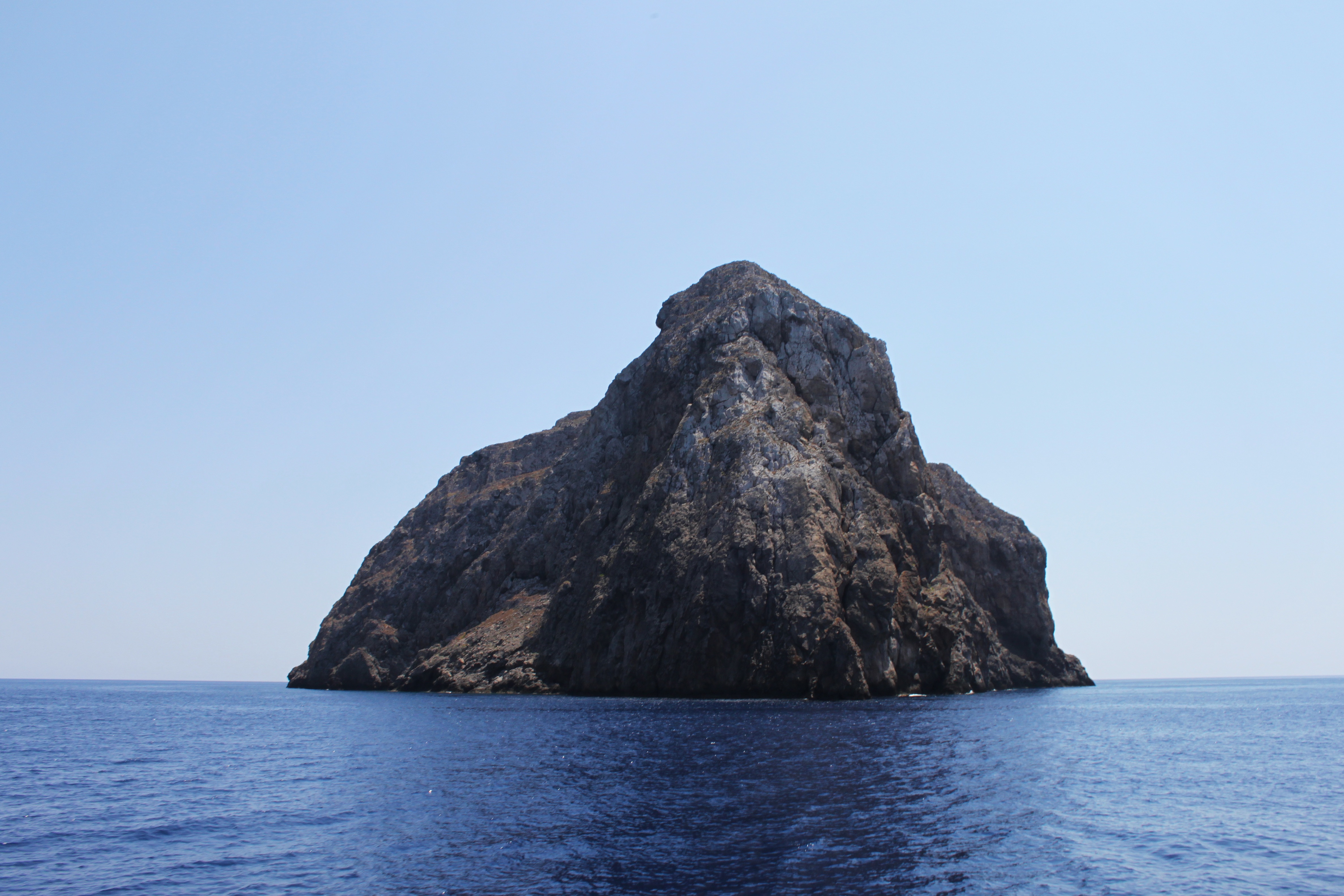A huge rock in the middle of the sea near the shore