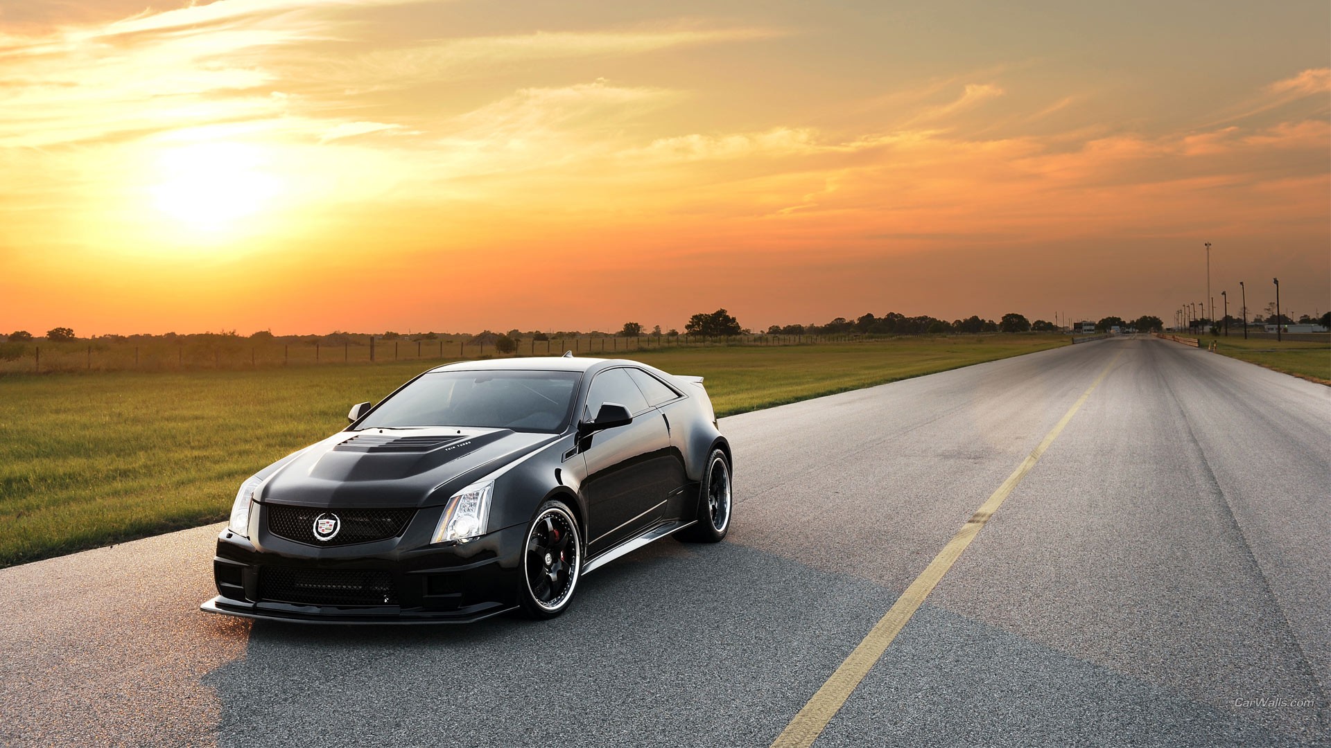 Free photo A black Cadillac CTS V at sunset.