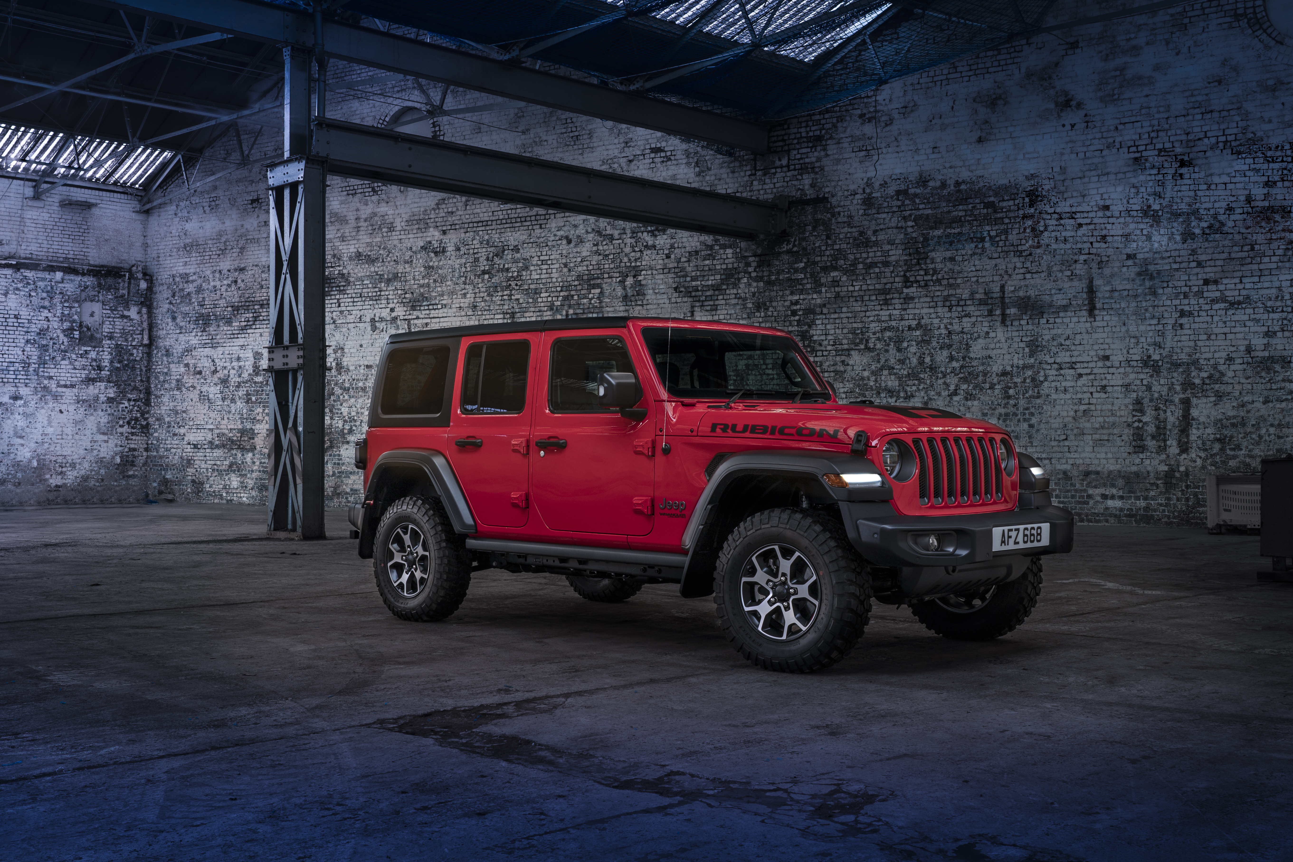 Free photo Jeep Wrangler in a big abandoned hangar.