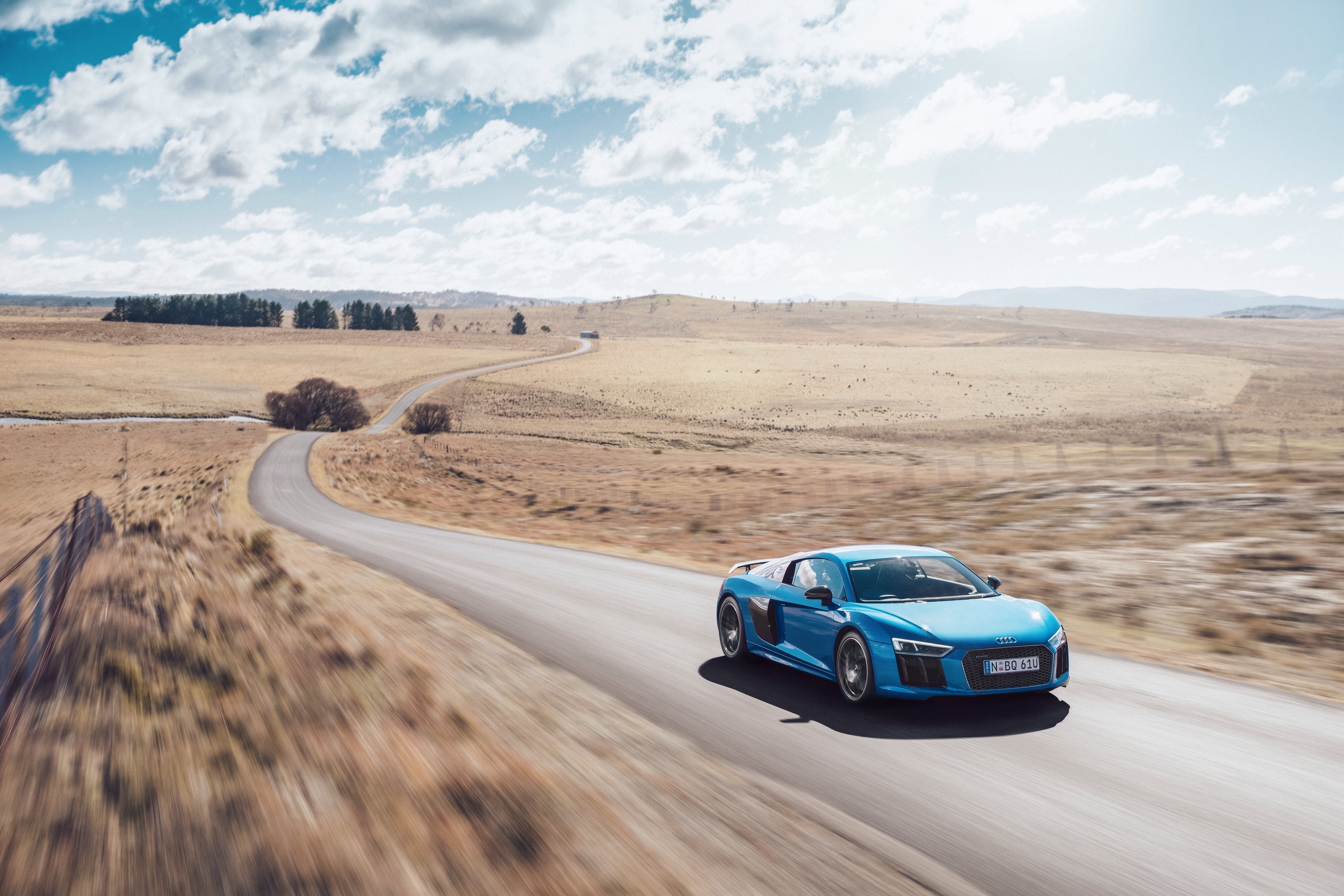 Free photo Wallpaper with a blue audi r8 v10 in desert terrain