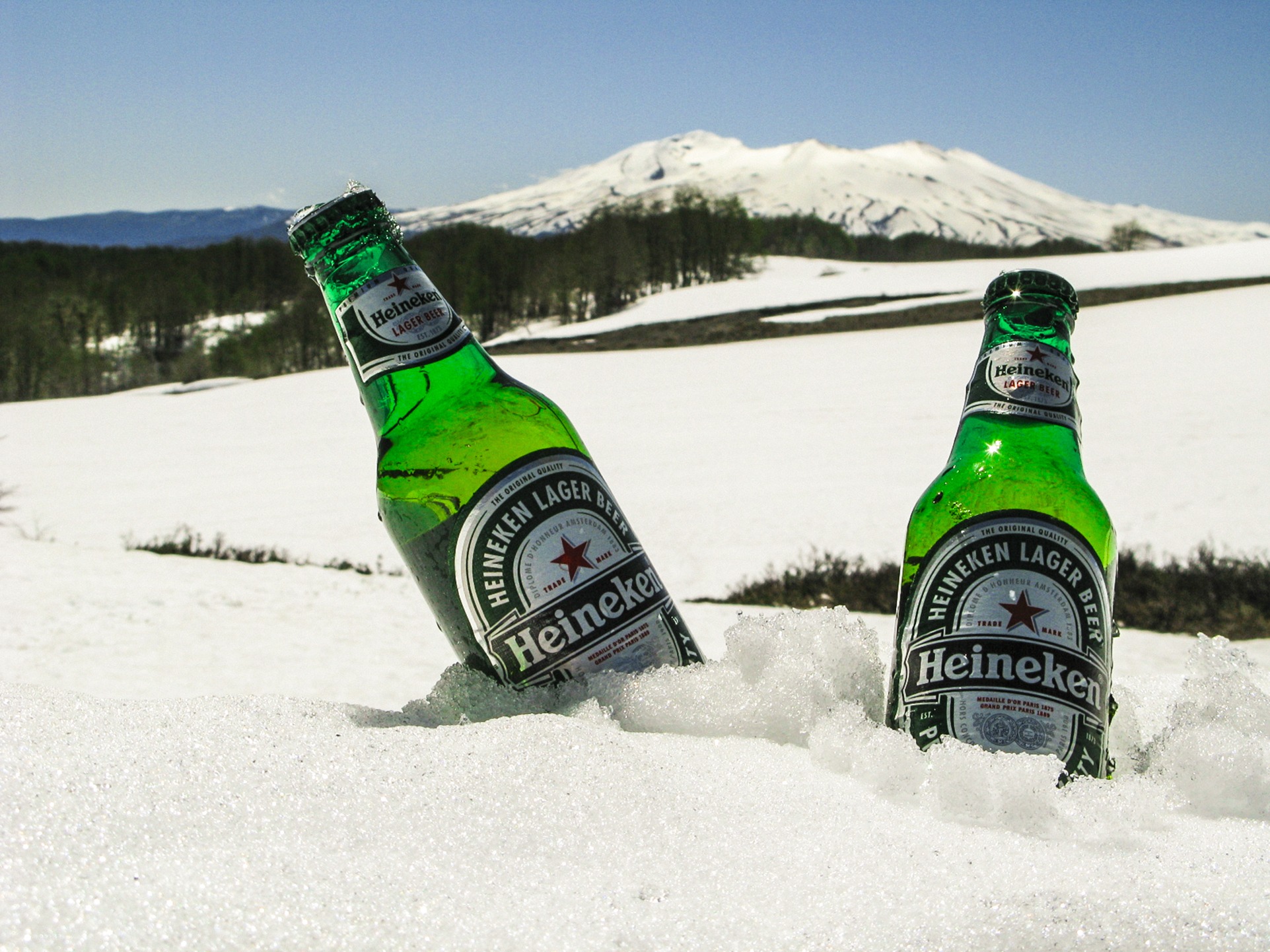Two bottles of Heineken beer chilled in the snow