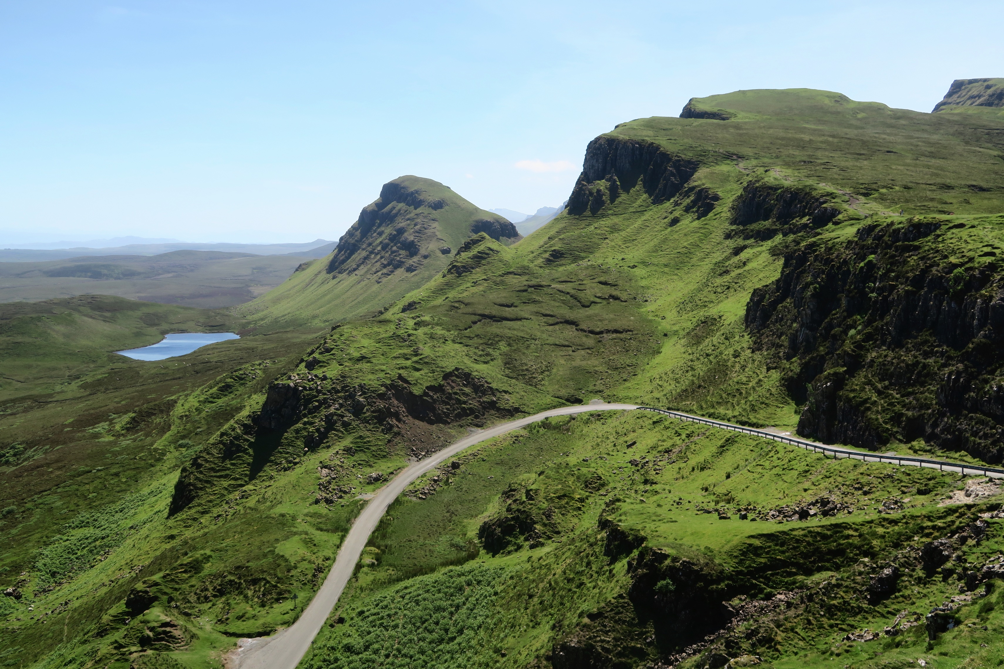 Free photo The green hills of the mountain with the road rising to the top