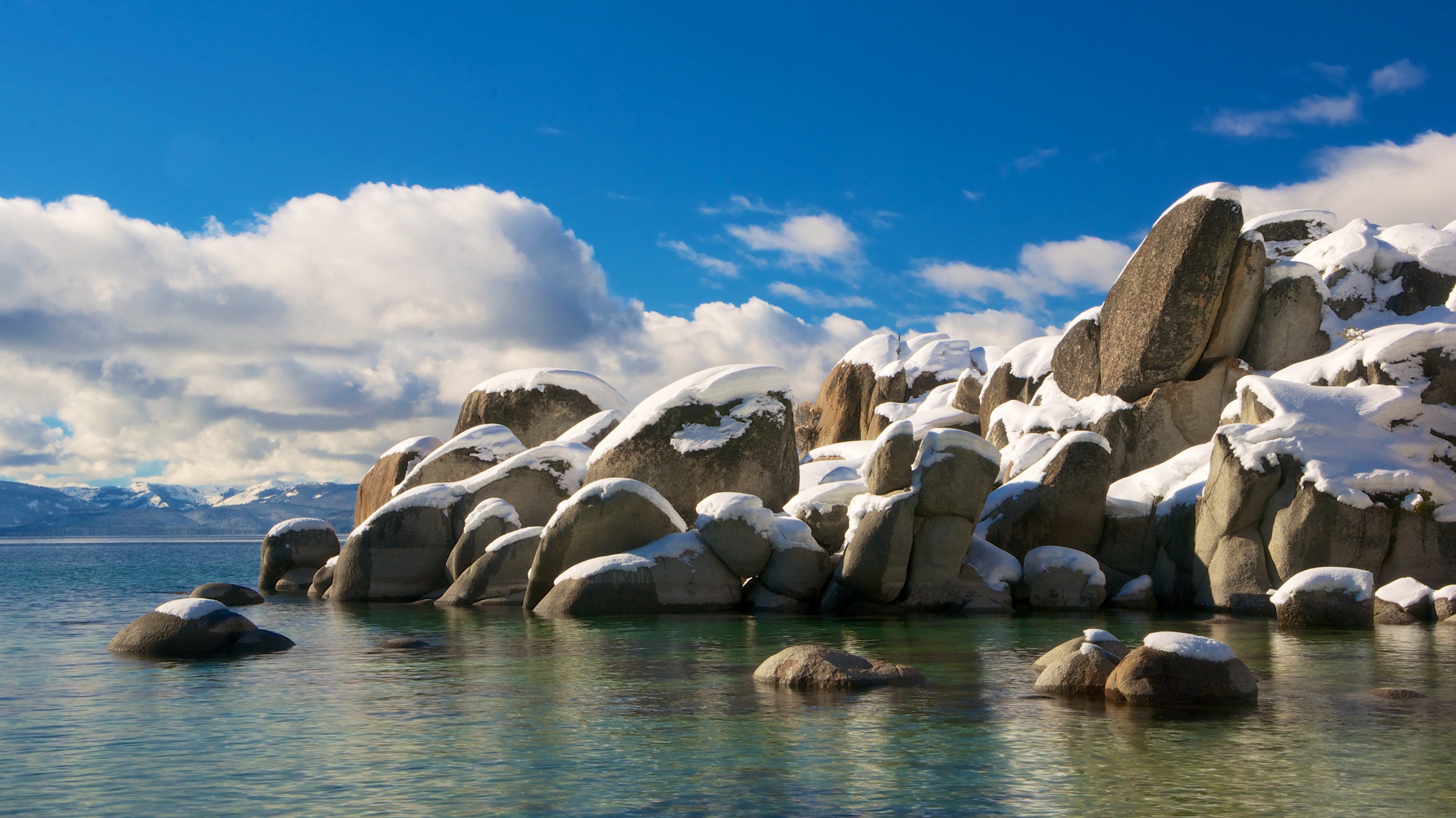 Snow caps on sea rocks