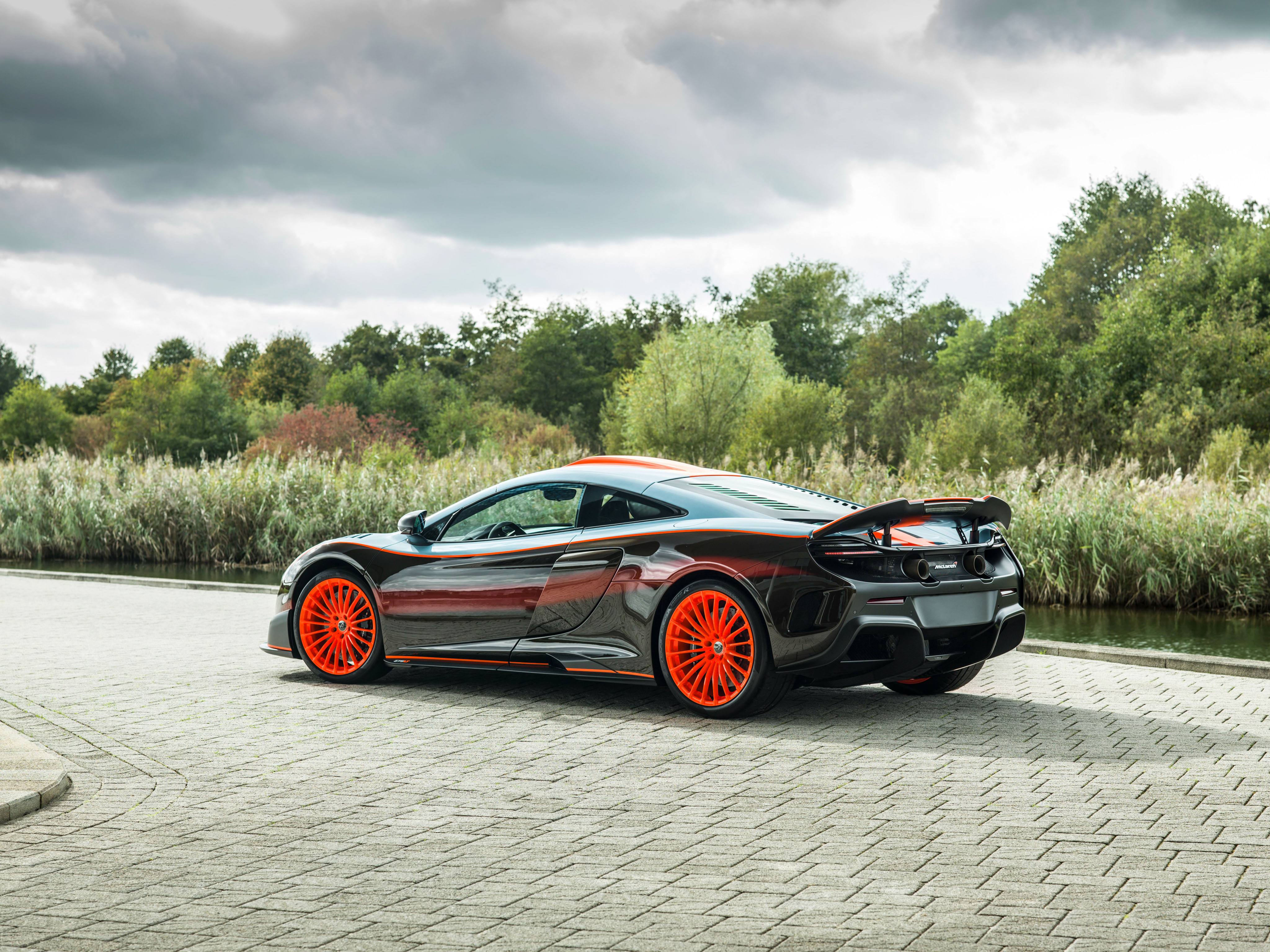 Free photo Black McLaren MSO 675 LT with orange rims