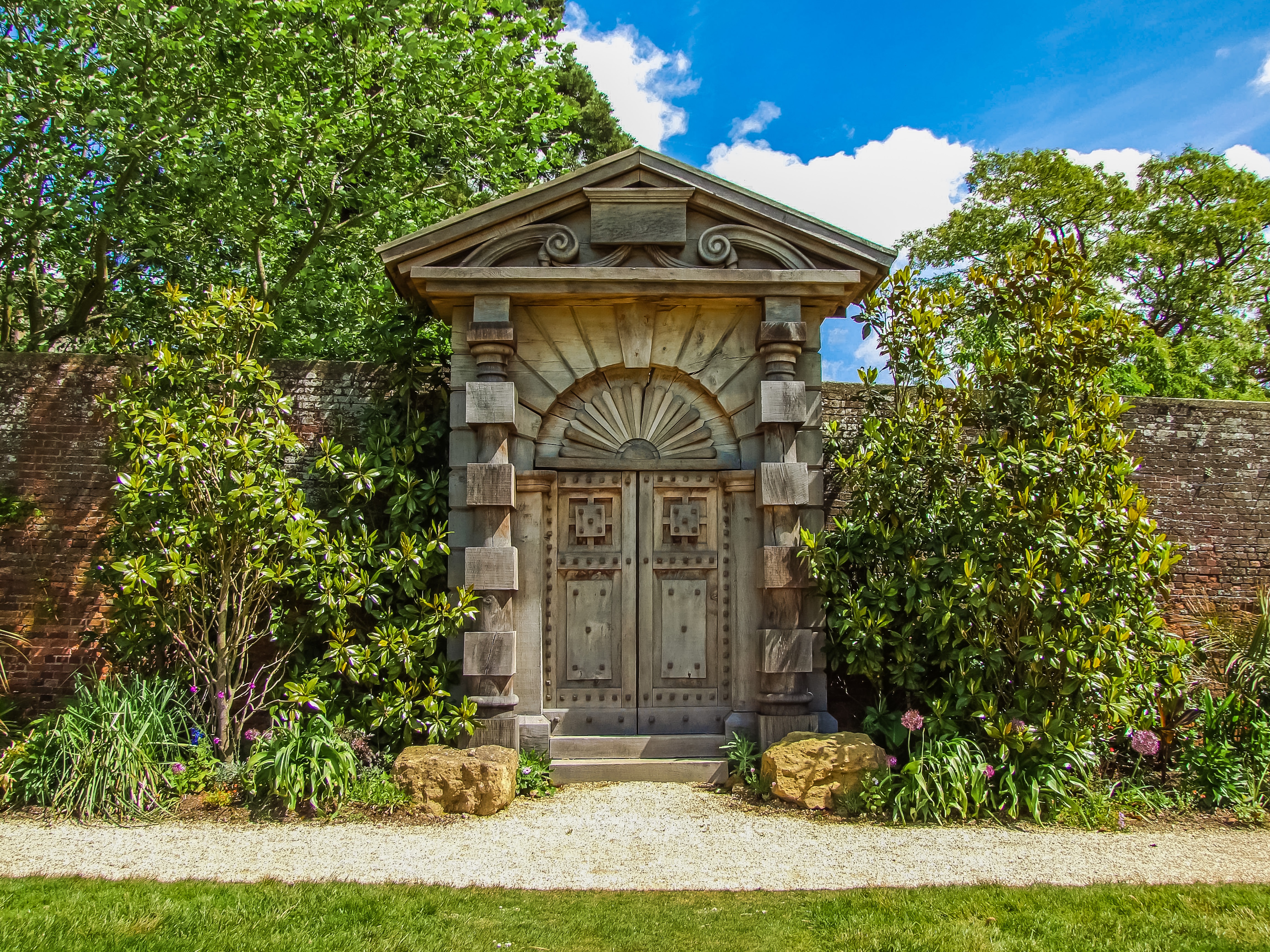 Free photo A wooden old gate in a stone wall