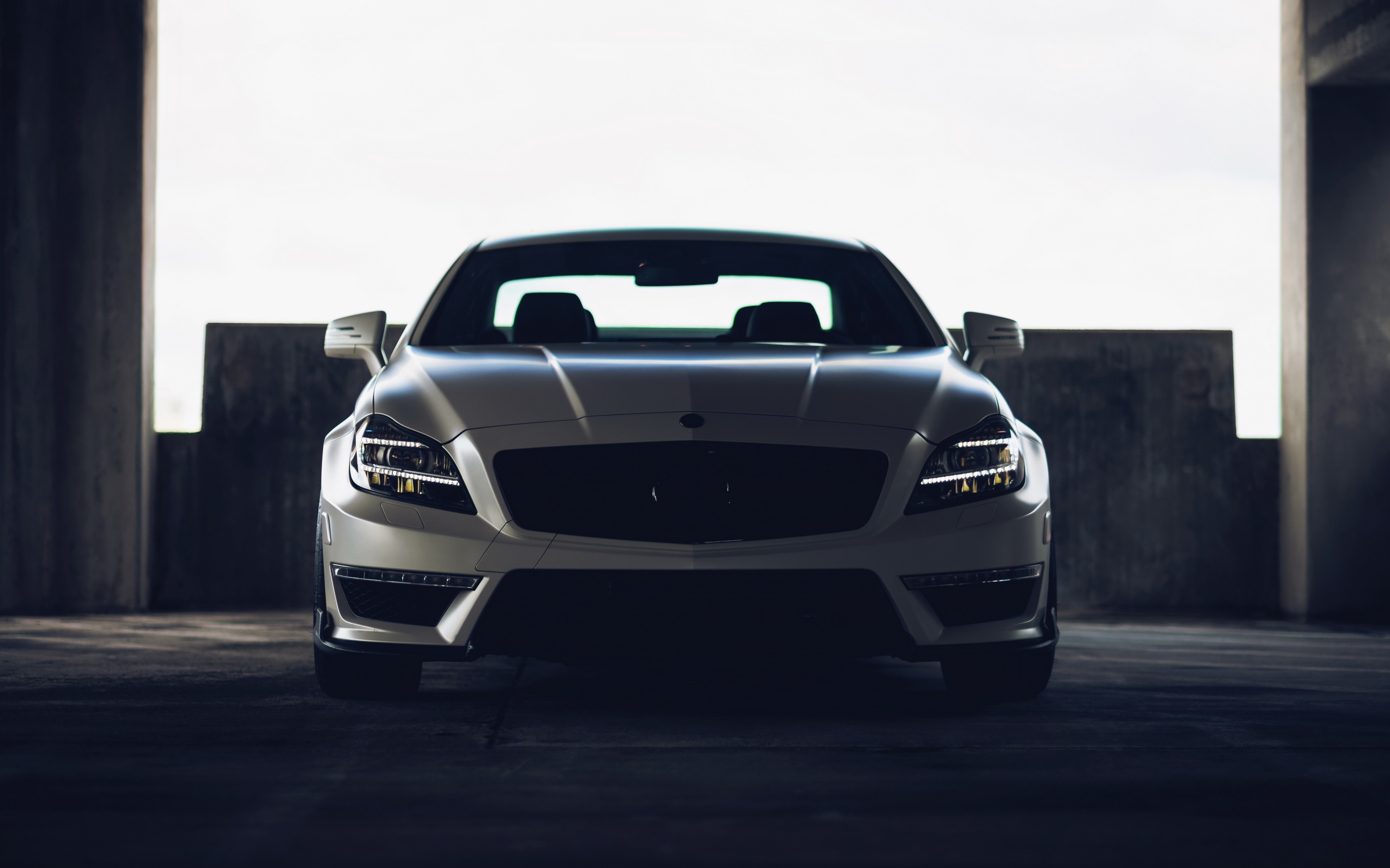 Free photo A white Benz CLS 63 AMG in an underground parking lot.