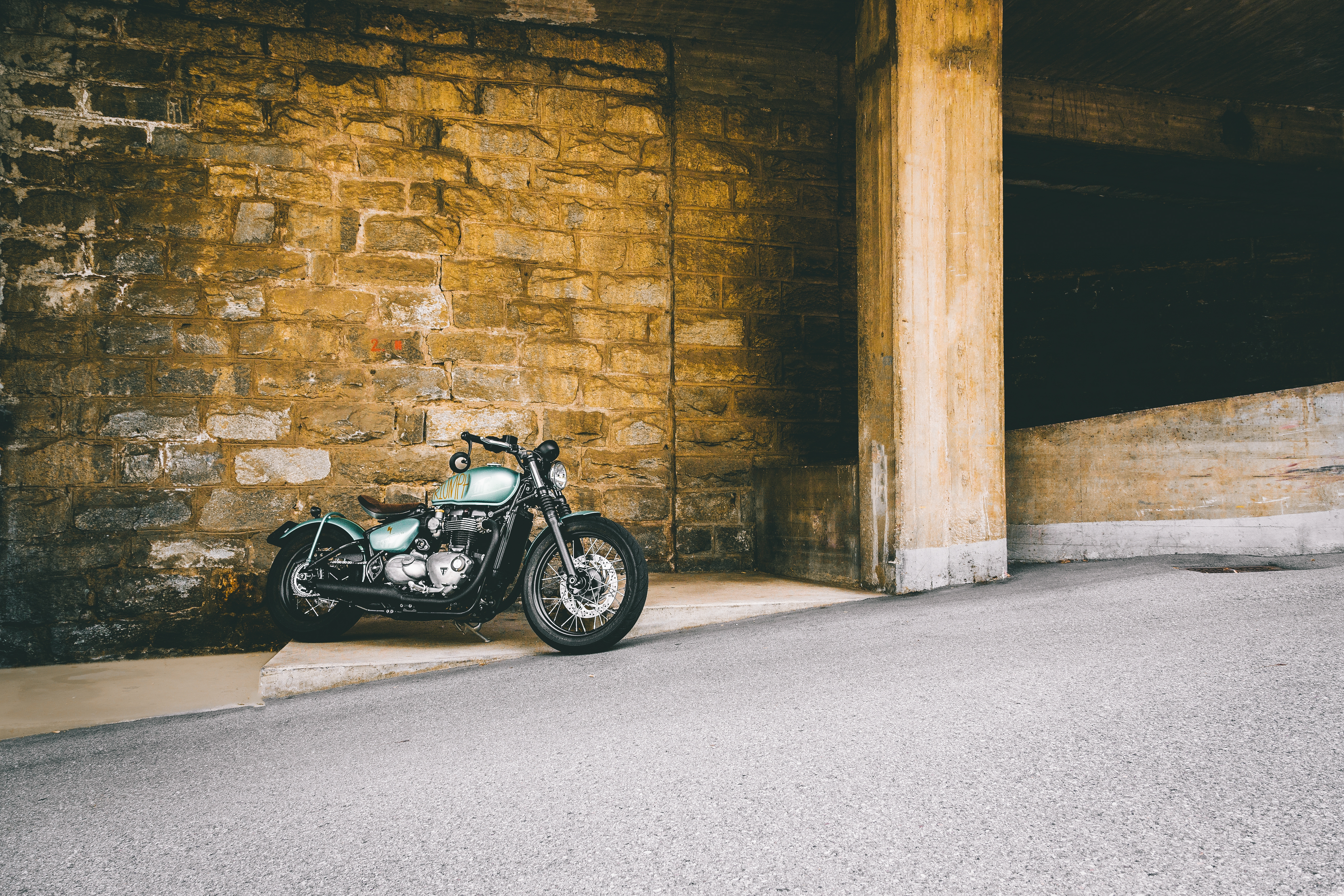 Free photo Harley stands against a stone wall