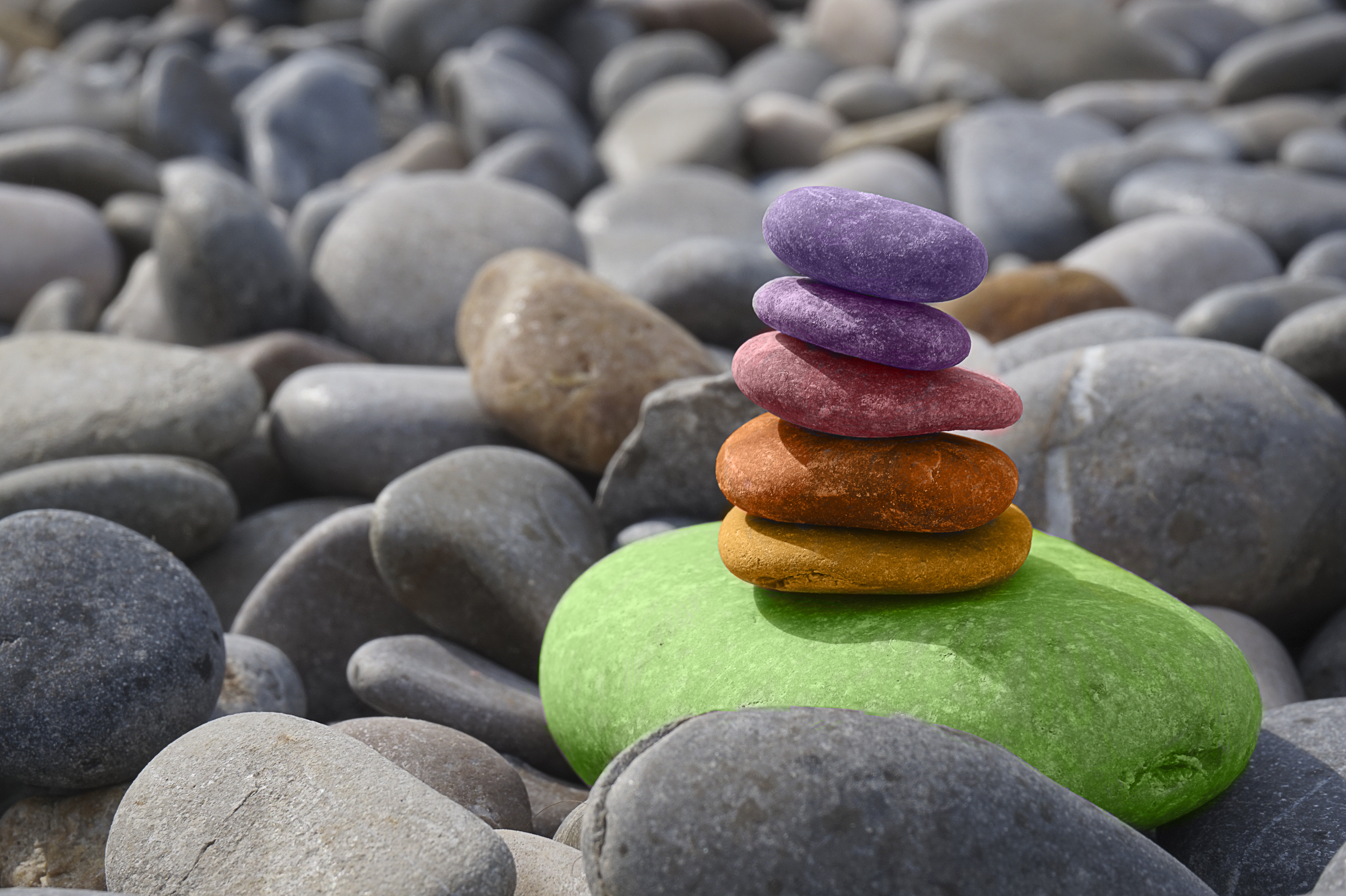 Free photo A pyramid of colorful pebbles on the seashore