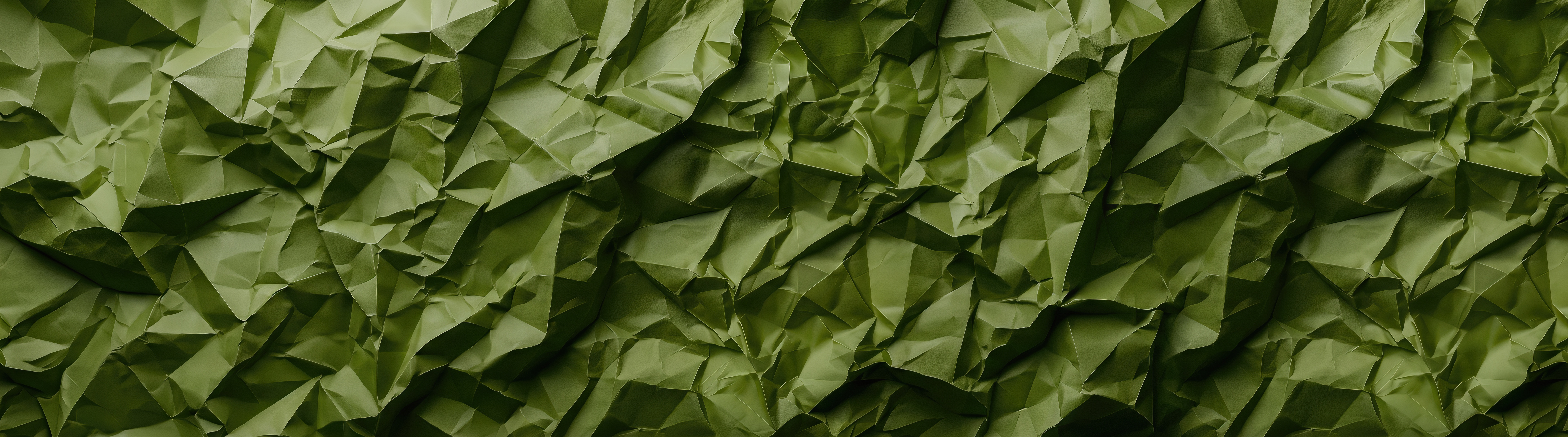 Free photo A close-up of a heavily jammed sheet of protective green paper with a complex grid of kinks.