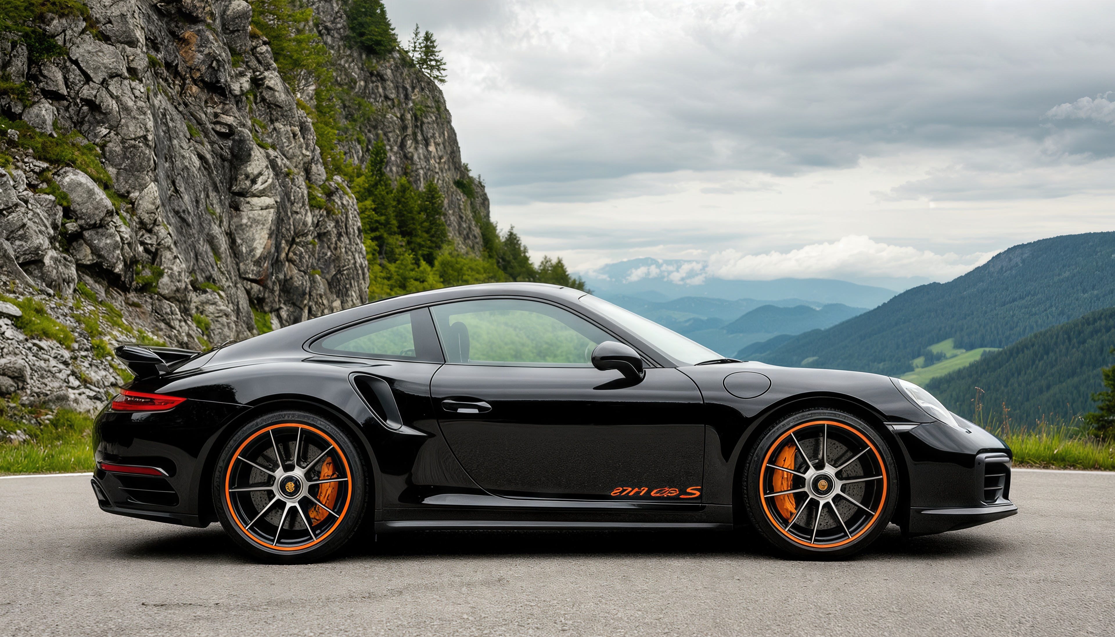 Free photo Black Porsche 911 Turbo S on a mountain road amidst majestic scenery.