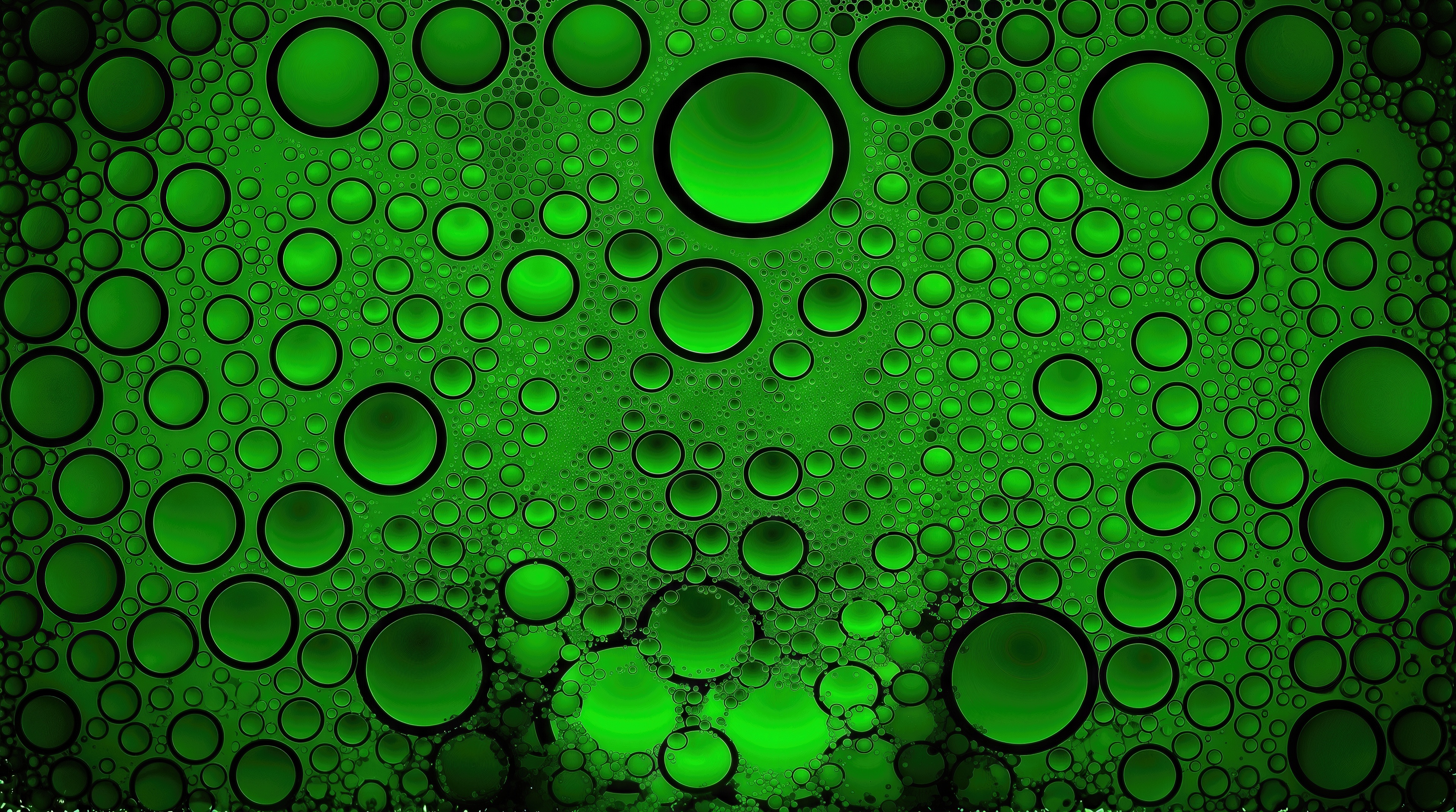 Free photo Stylish abstraction with lots of round oil bubbles of different diameters on a bright green background.