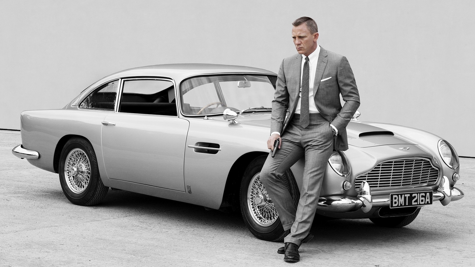 Free photo james bond with vintage ast martin.