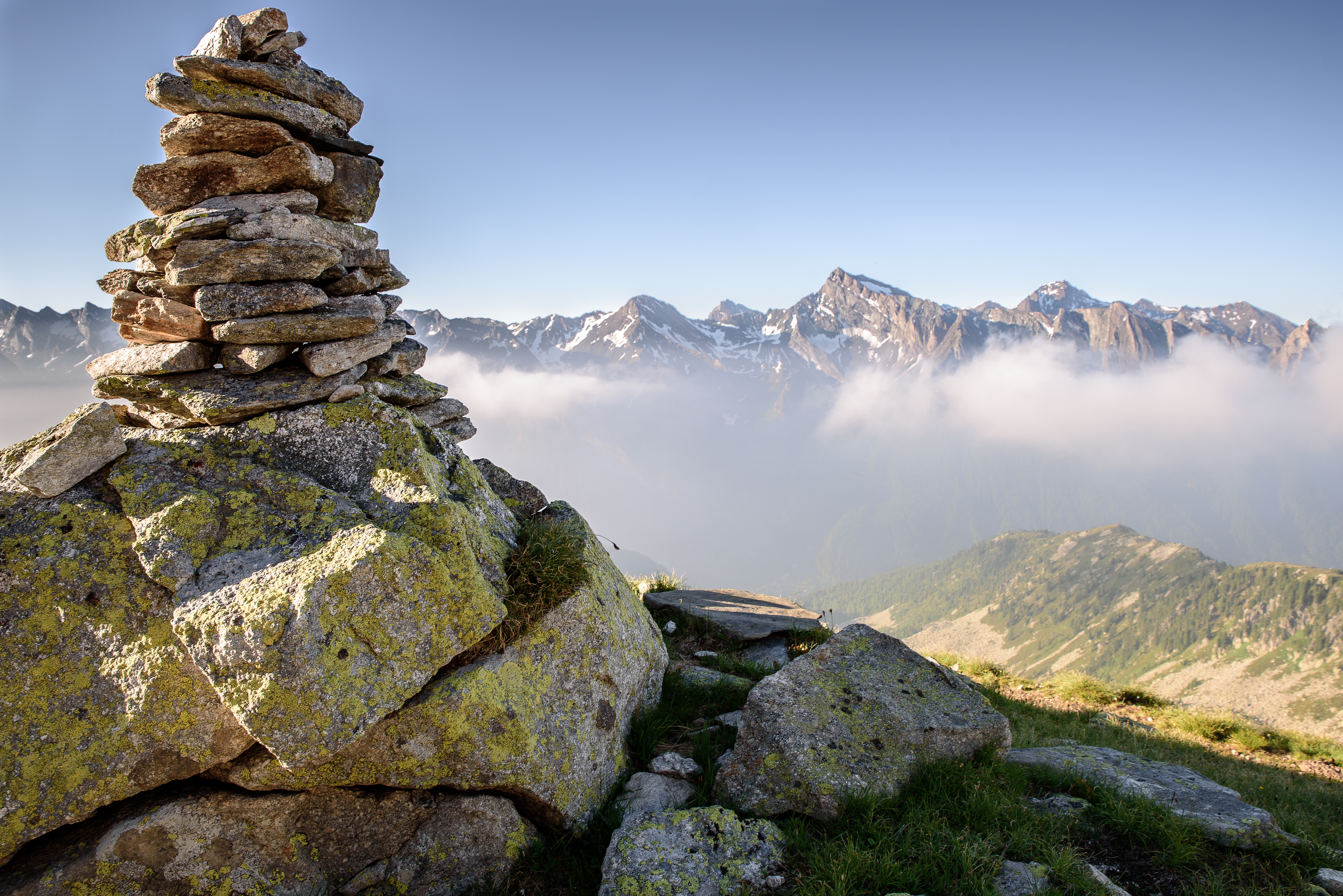 Free photo On top of the mountain stacked stones on top of each other