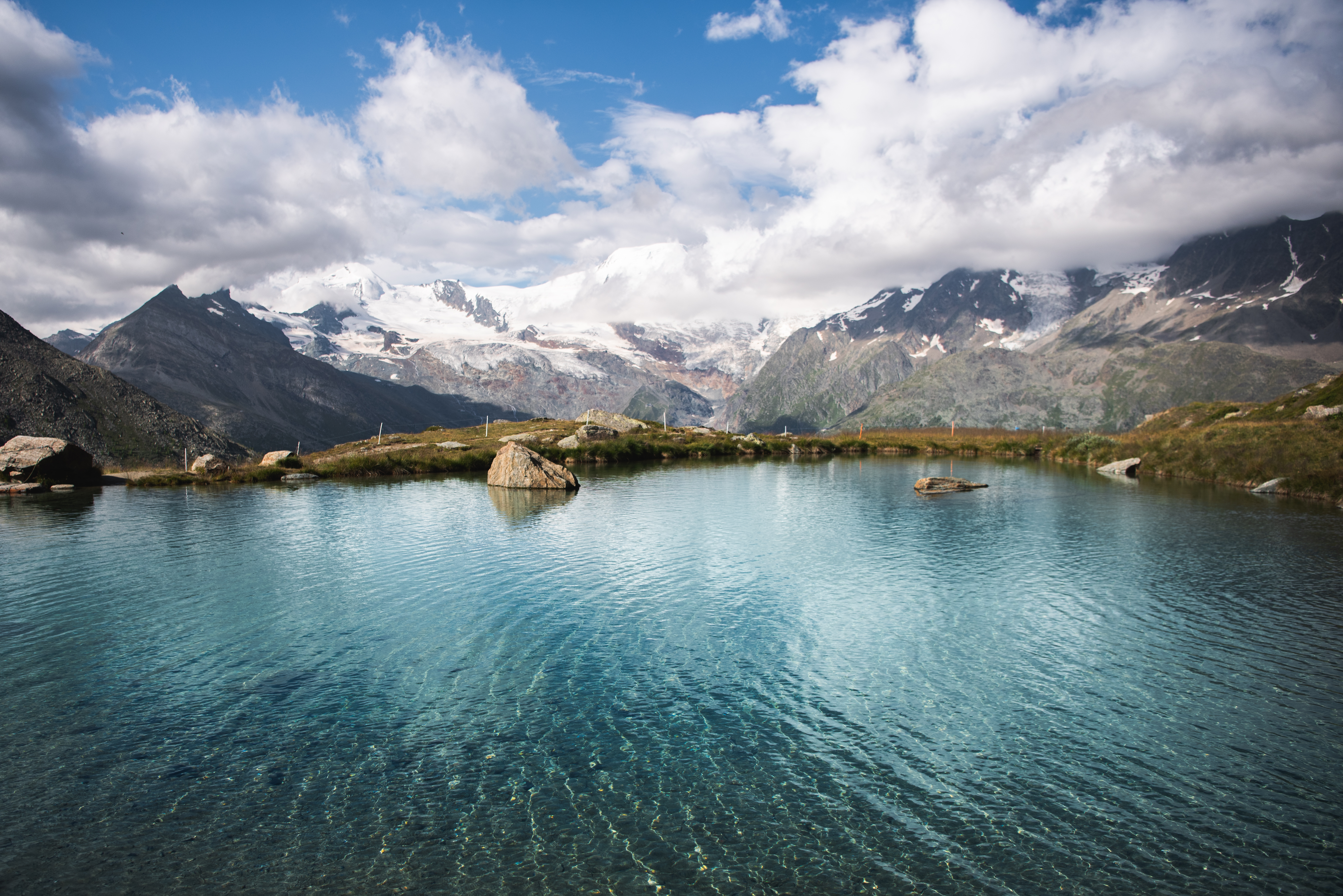 Free photo A small lake of melting snow in the mountains