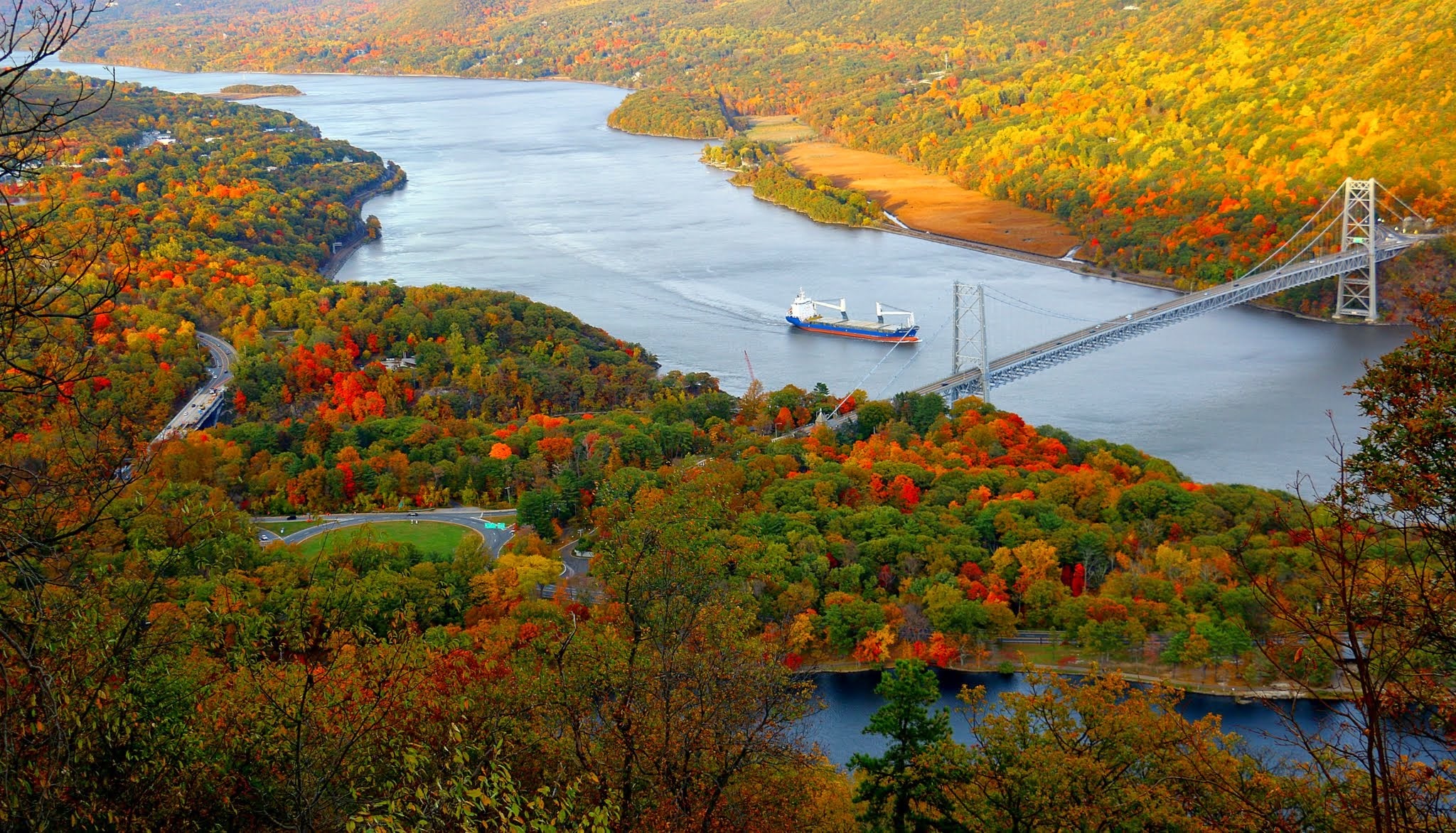 Free photo A ship goes down a river with fall shores