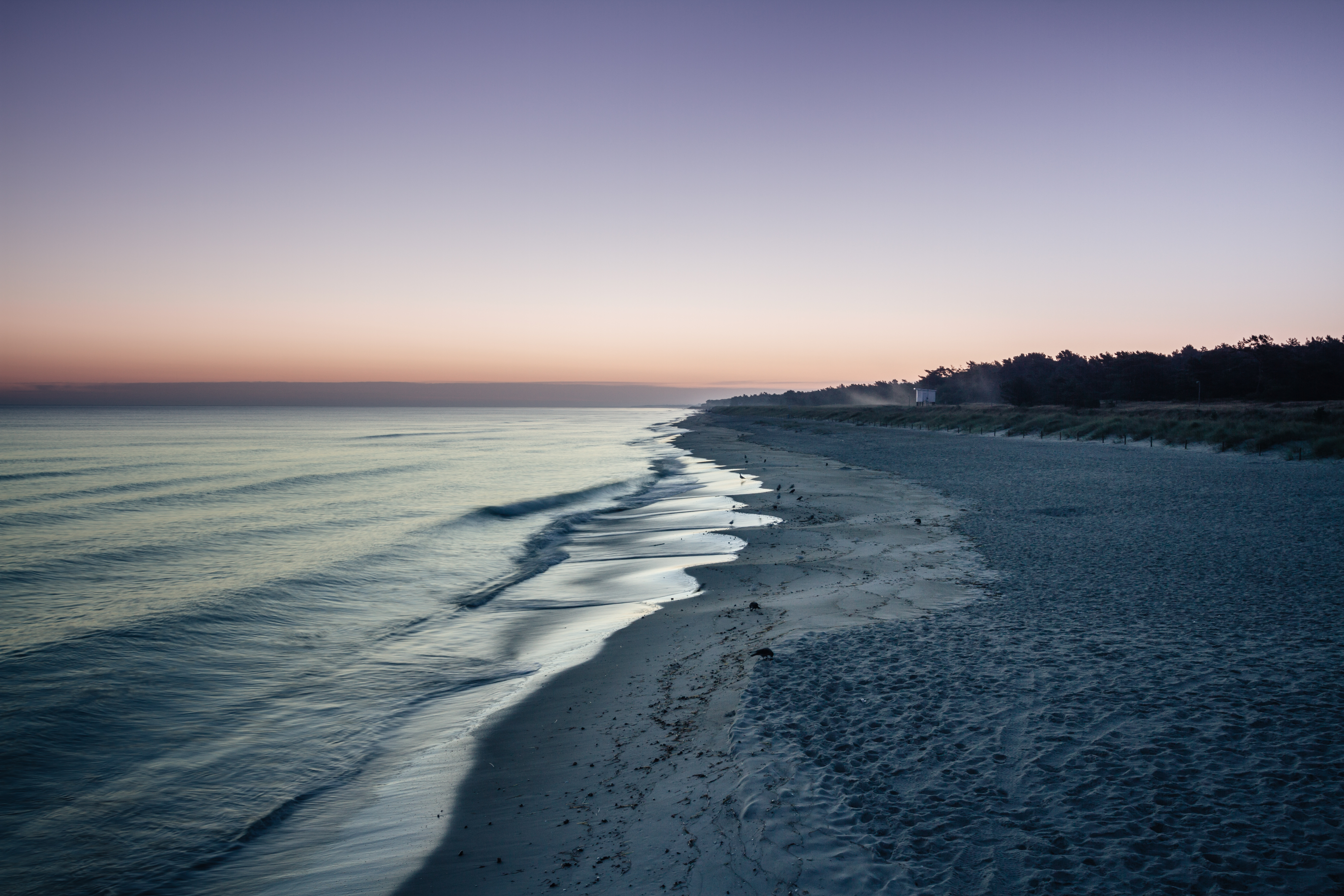 White sand shoreline at sunset