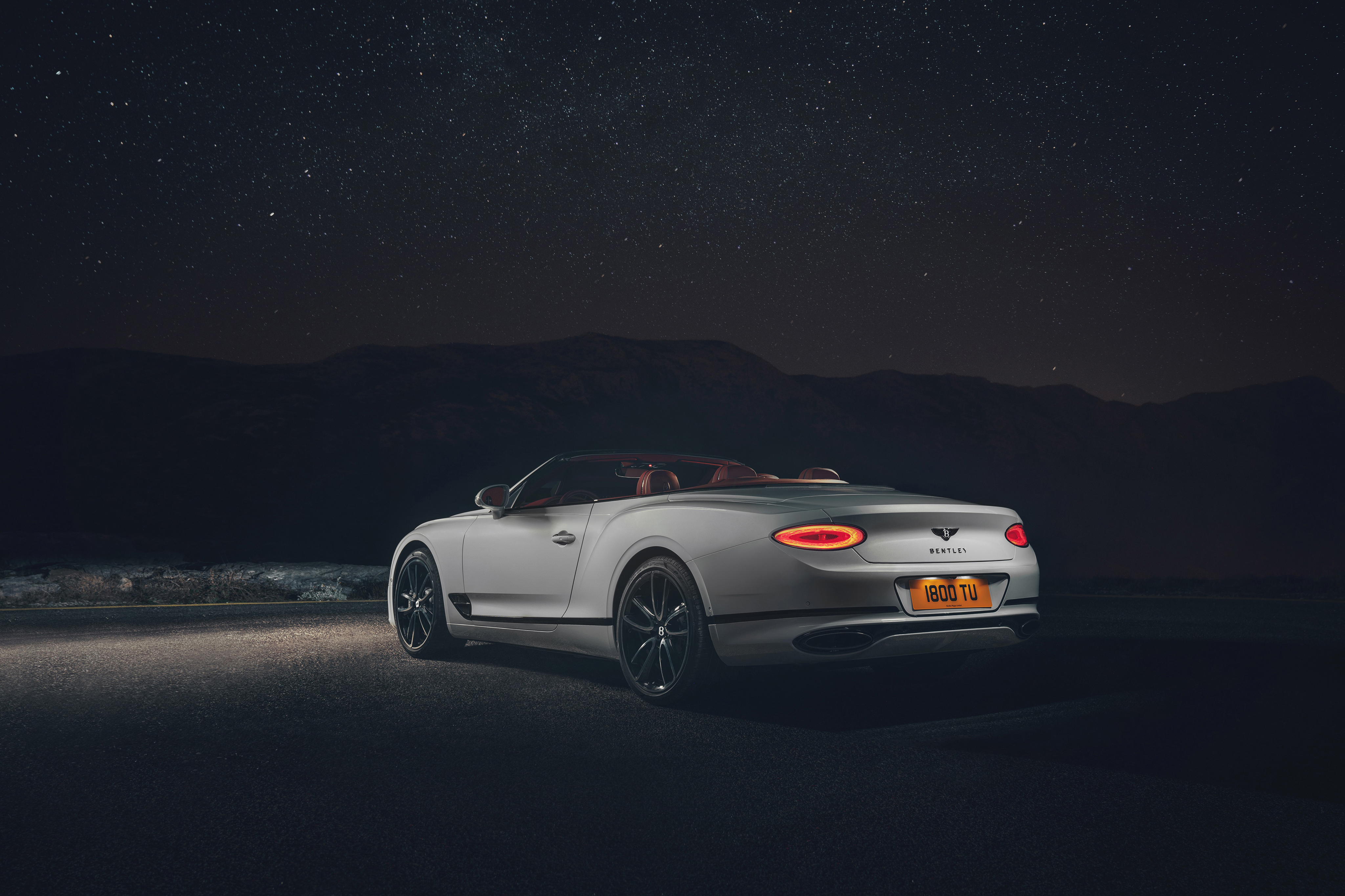 Free photo Bentley Continental GT convertible at night, rear view