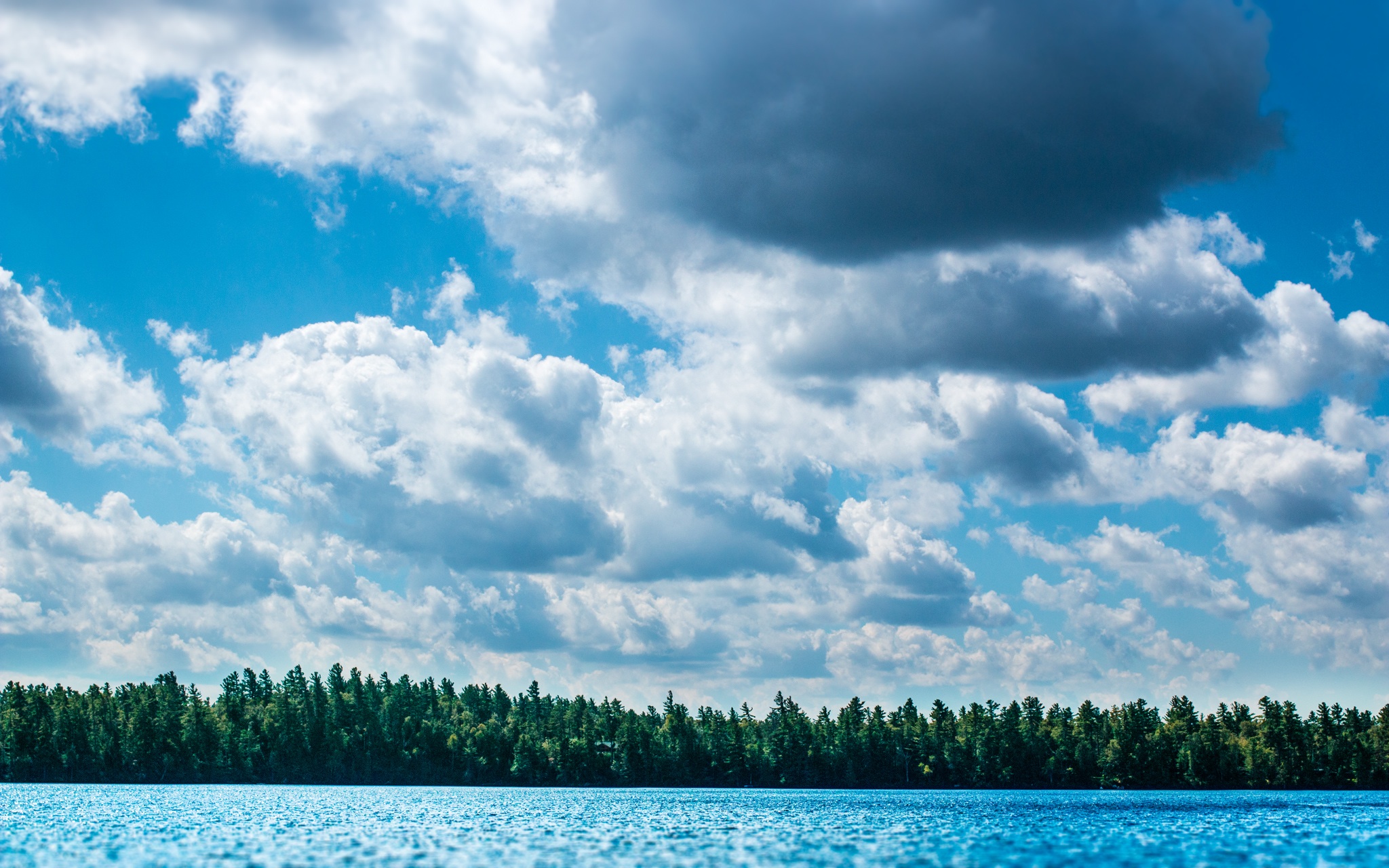 Free photo Cumulus clouds in summer over the lake