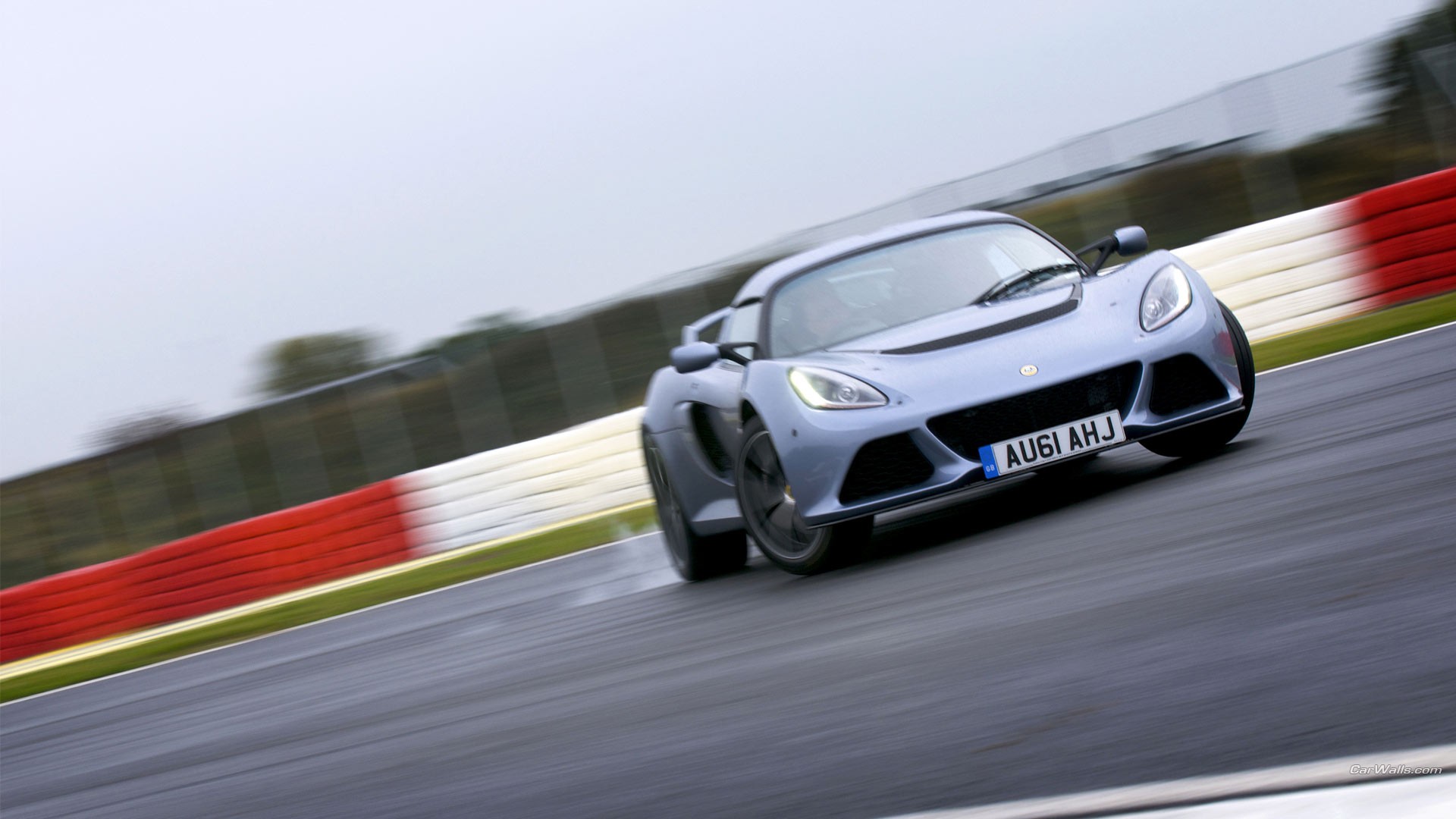 Free photo Lotus Exige racing on a sports track.