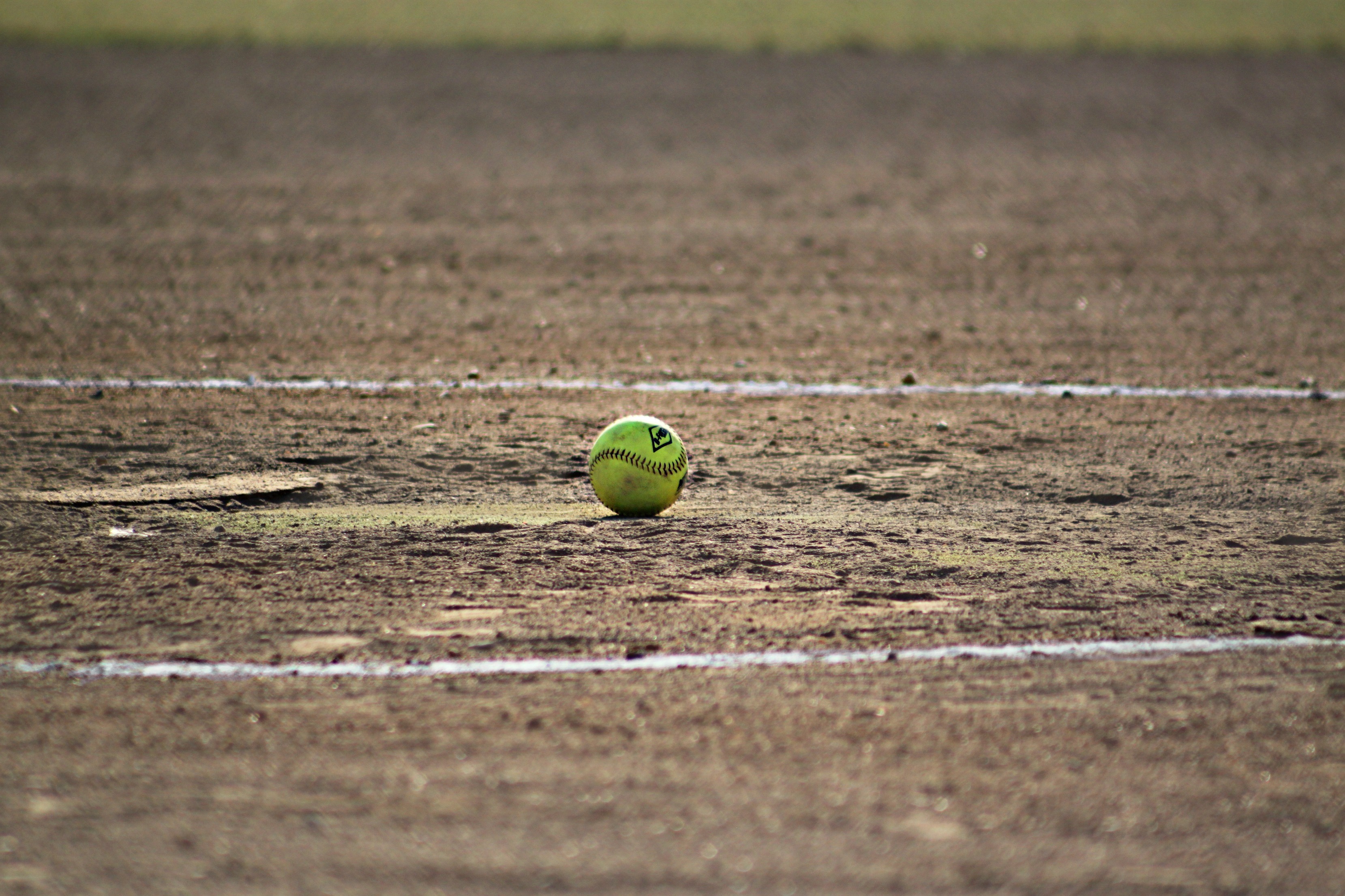 Free photo A baseball lies on a trampled field