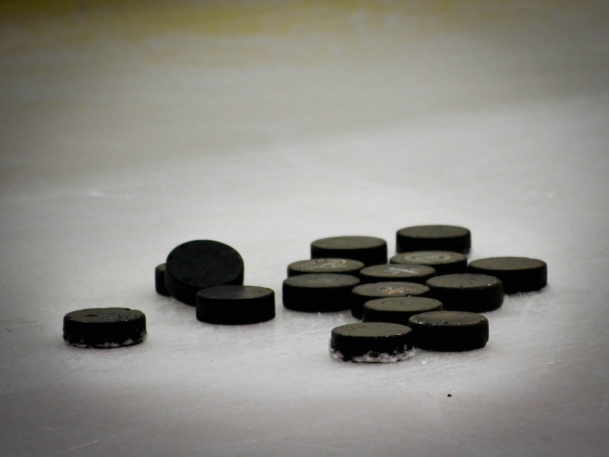 Hockey pucks on the ice.