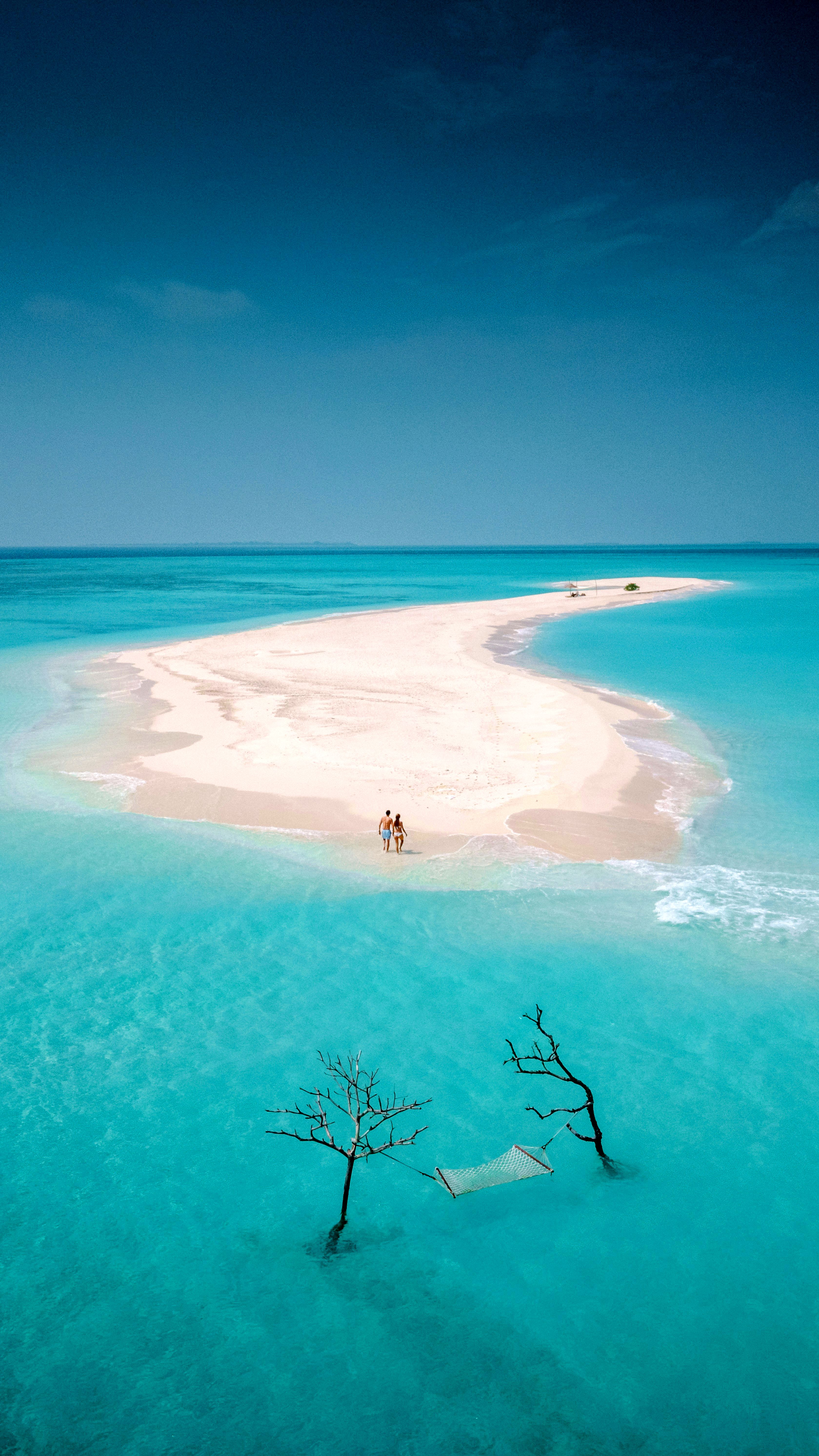 A couple on a sandy island.