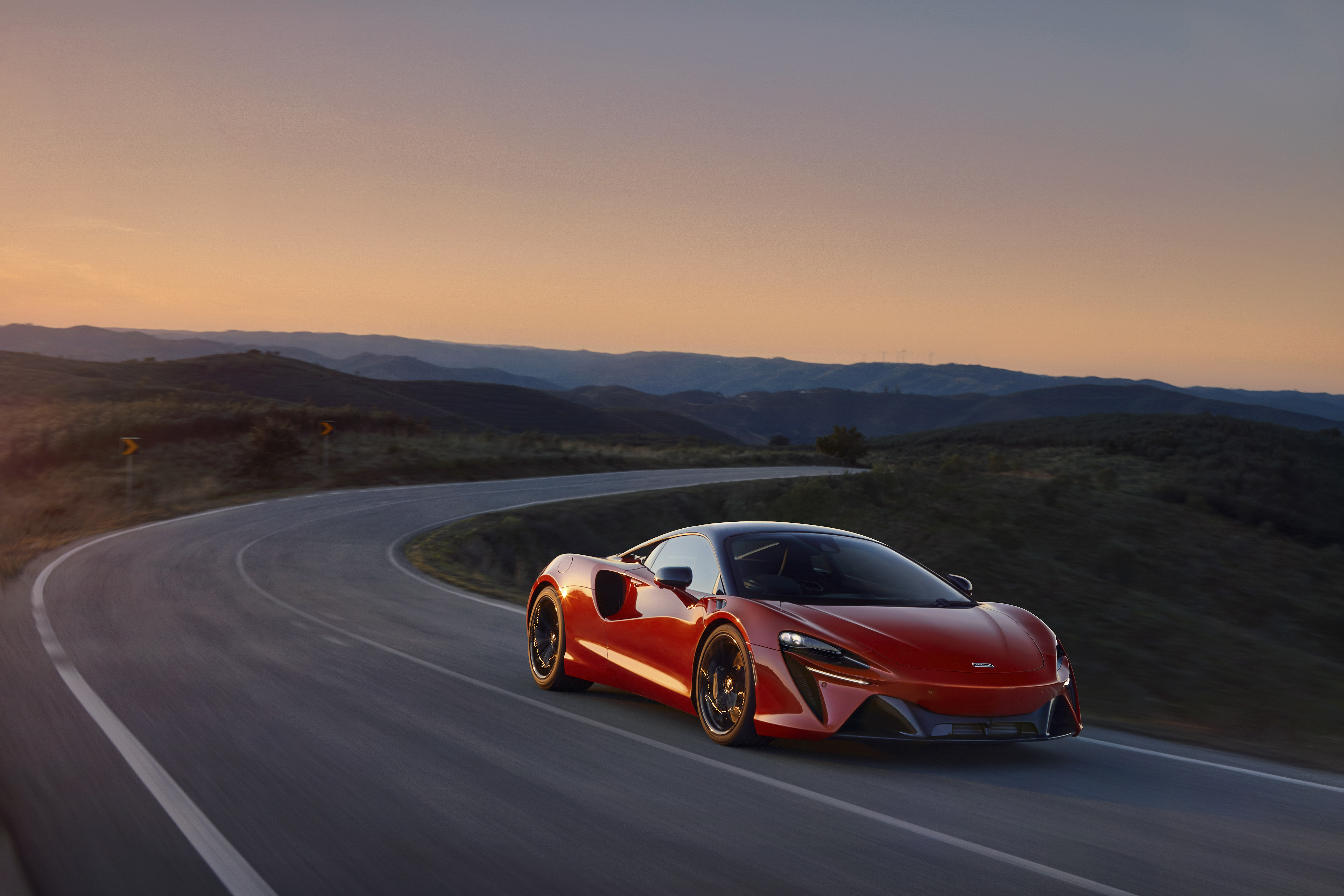 The Mclaren 2021 in red drives at high speed