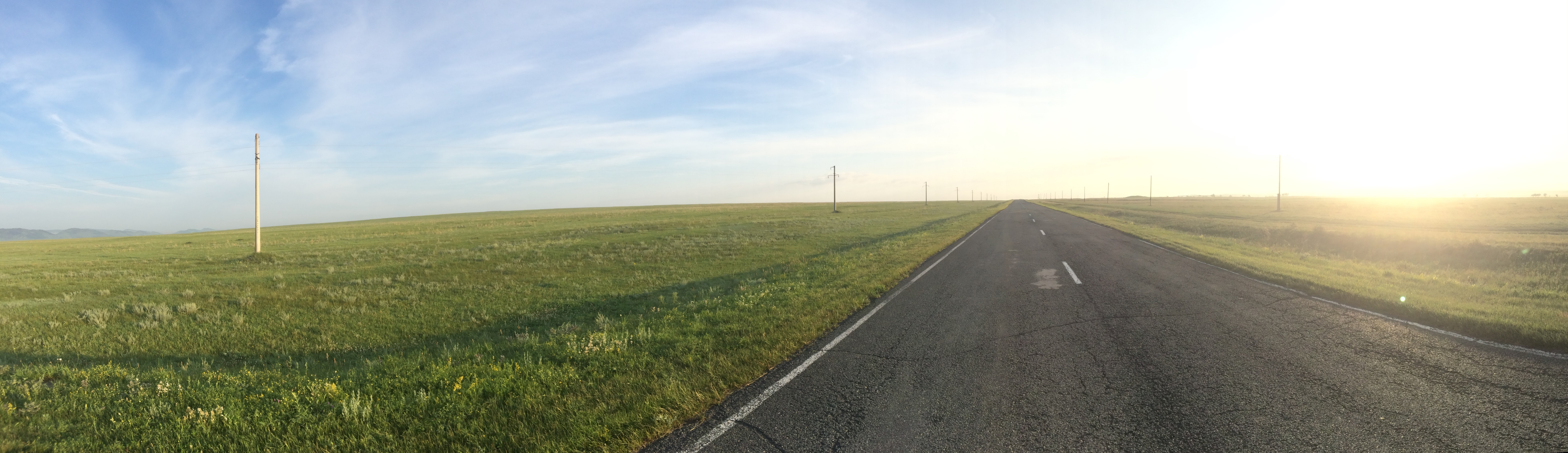 Free photo The asphalted steppe road goes into the sunset