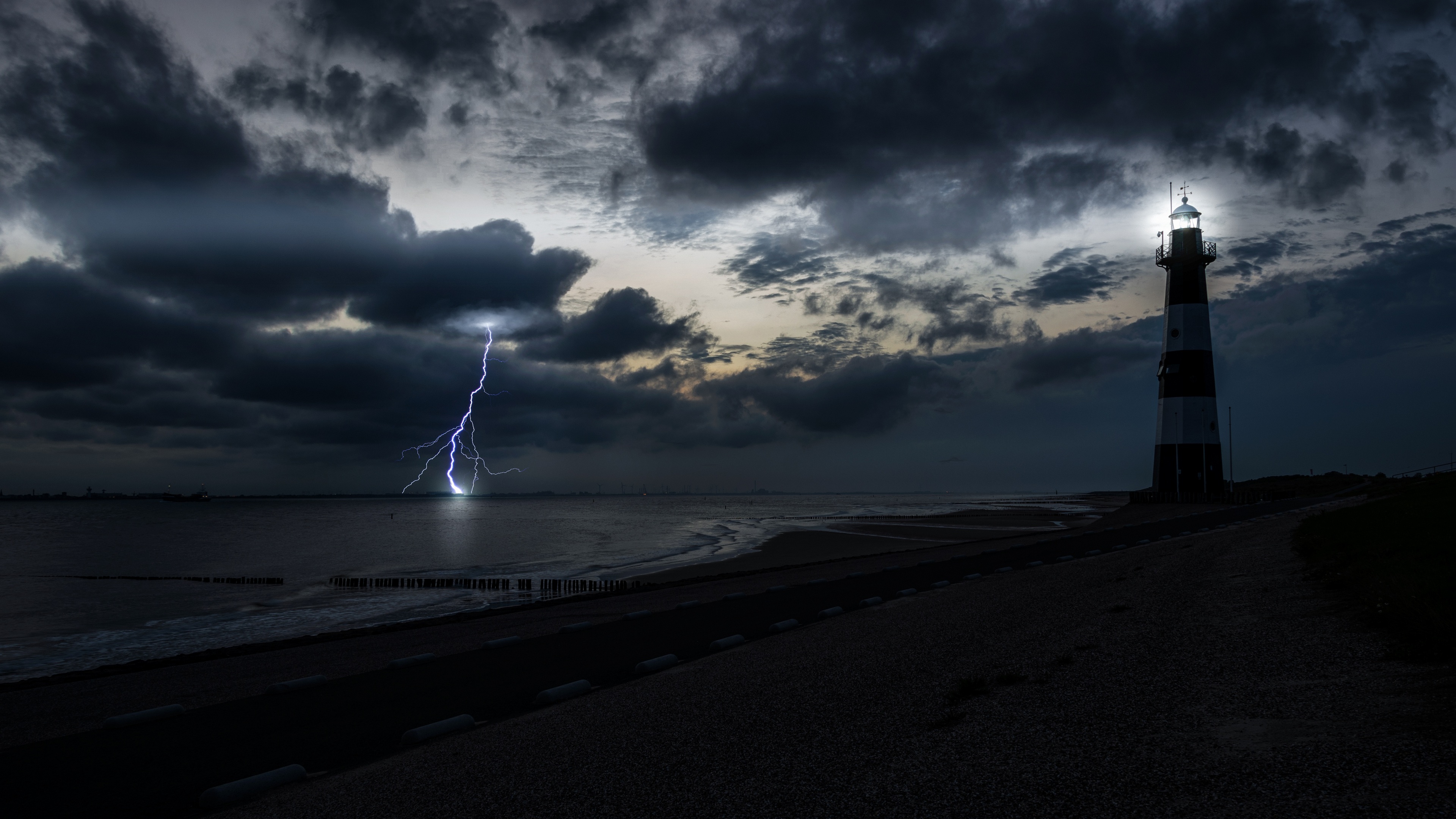 Free photo Night lightning during a storm near the lighthouse