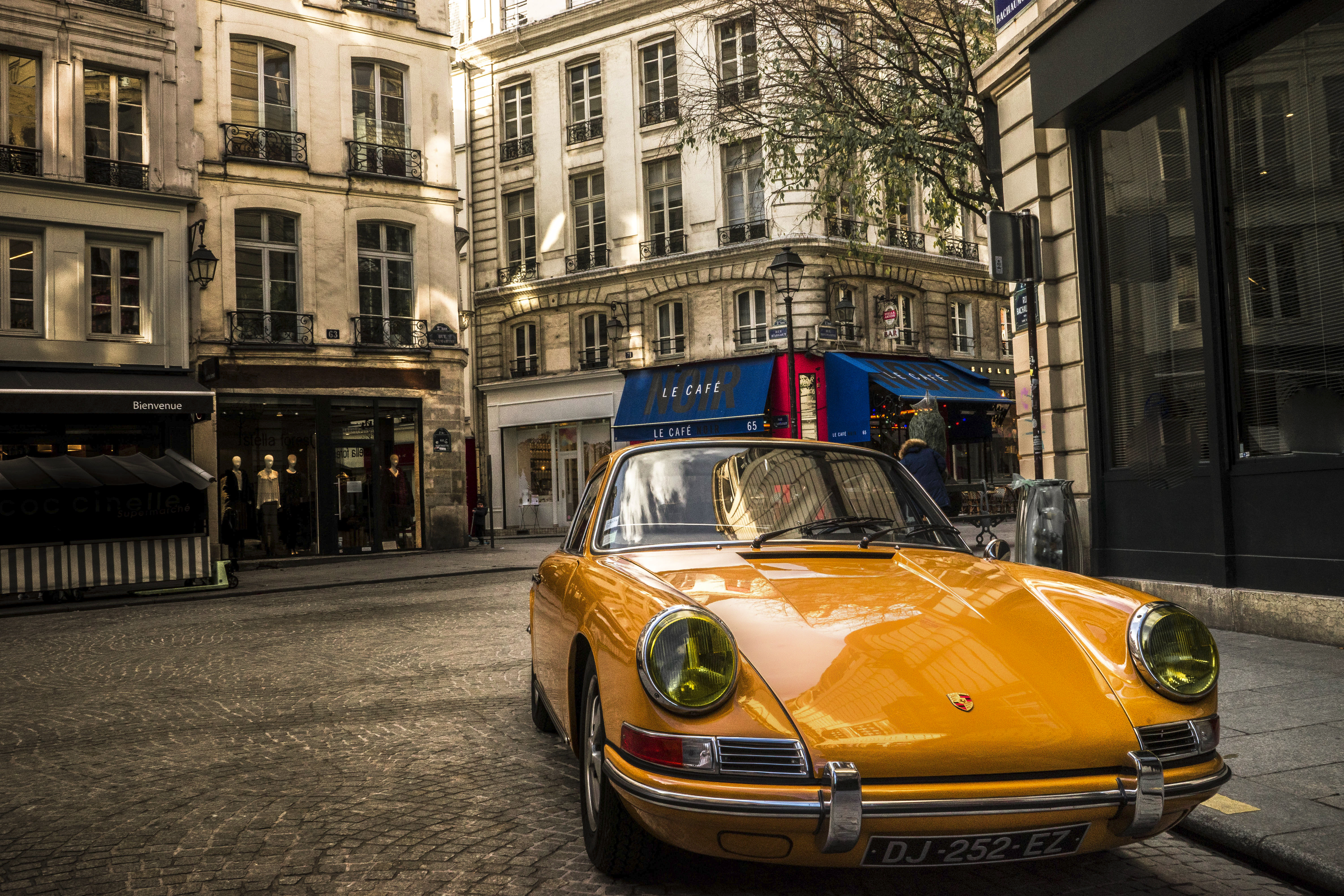 Vintage yellow Porsche on the streets of Paris