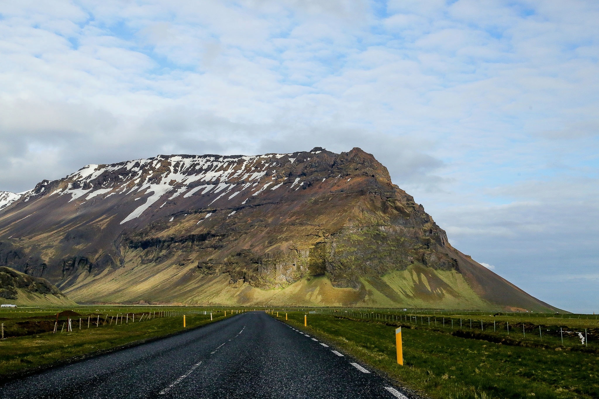 Free photo A long road by a high mountain